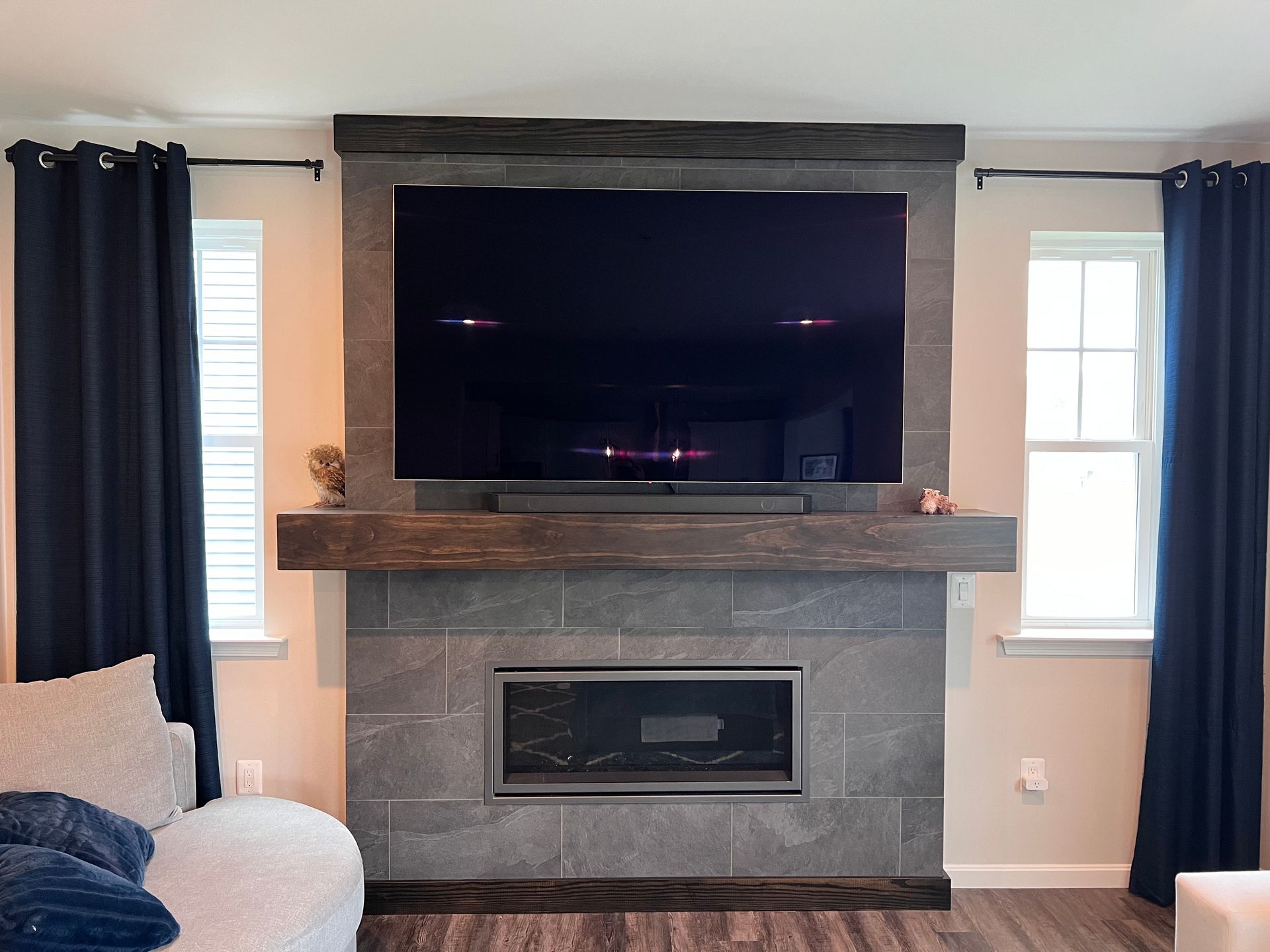 Custom-built fireplace surround with a mantel and TV in Milford Mill home.