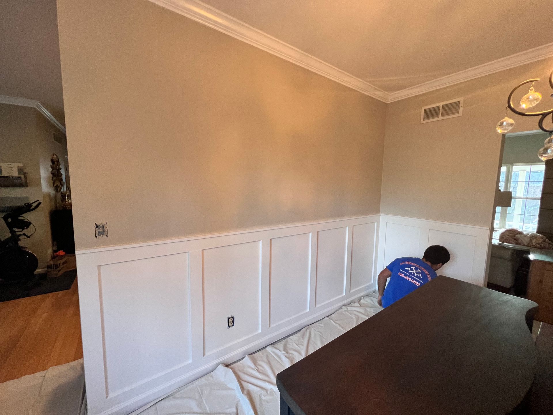 Dining room with custom-built bookcases and a shiplap accent wall.