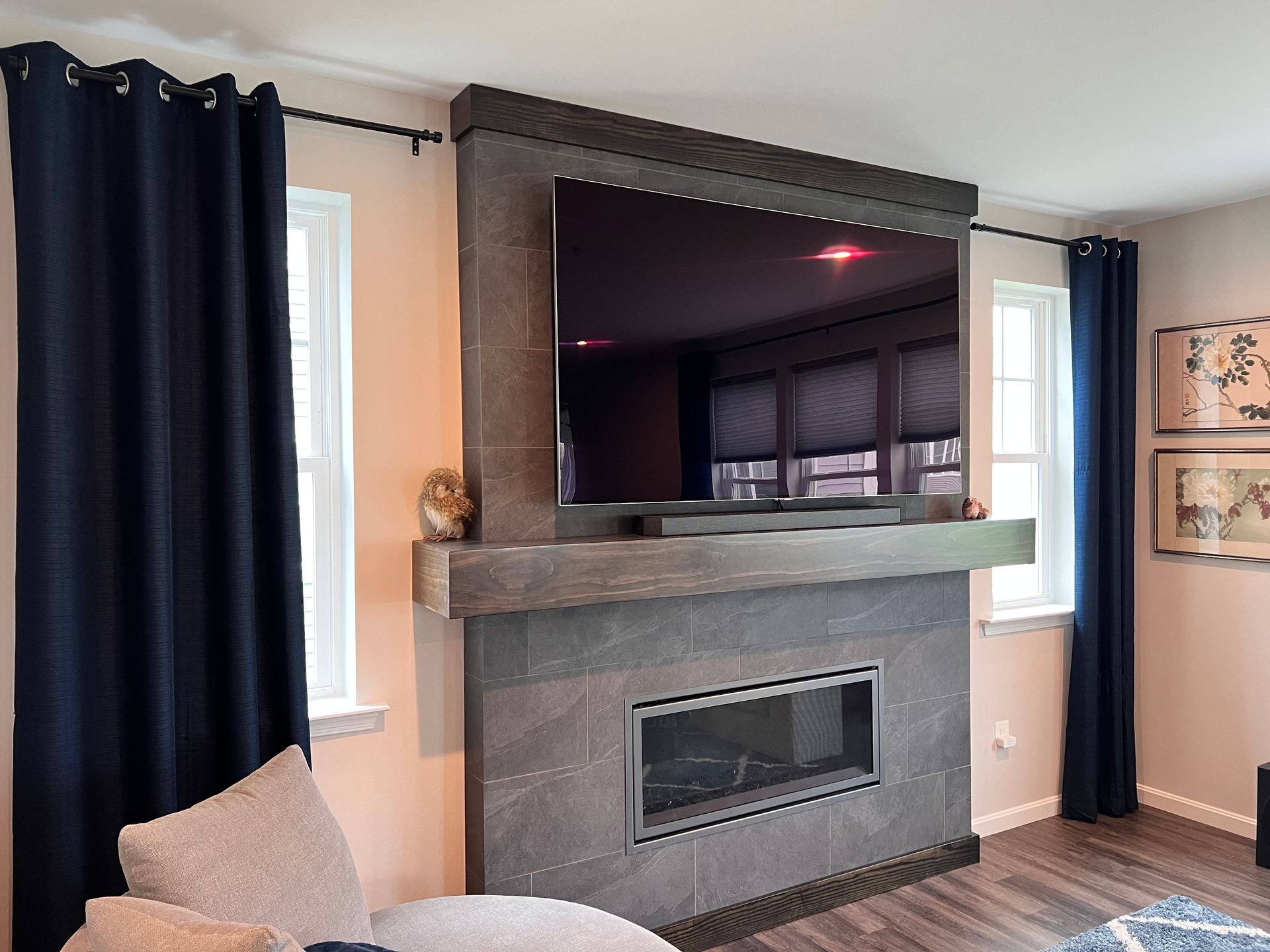 Custom fireplace surround with a mantel and integrated TV in Milford Mill home.