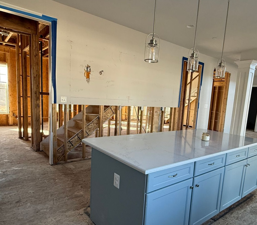 See the transformation of a kitchen from an unfinished space to a stunning open-concept remodel with a new central island.