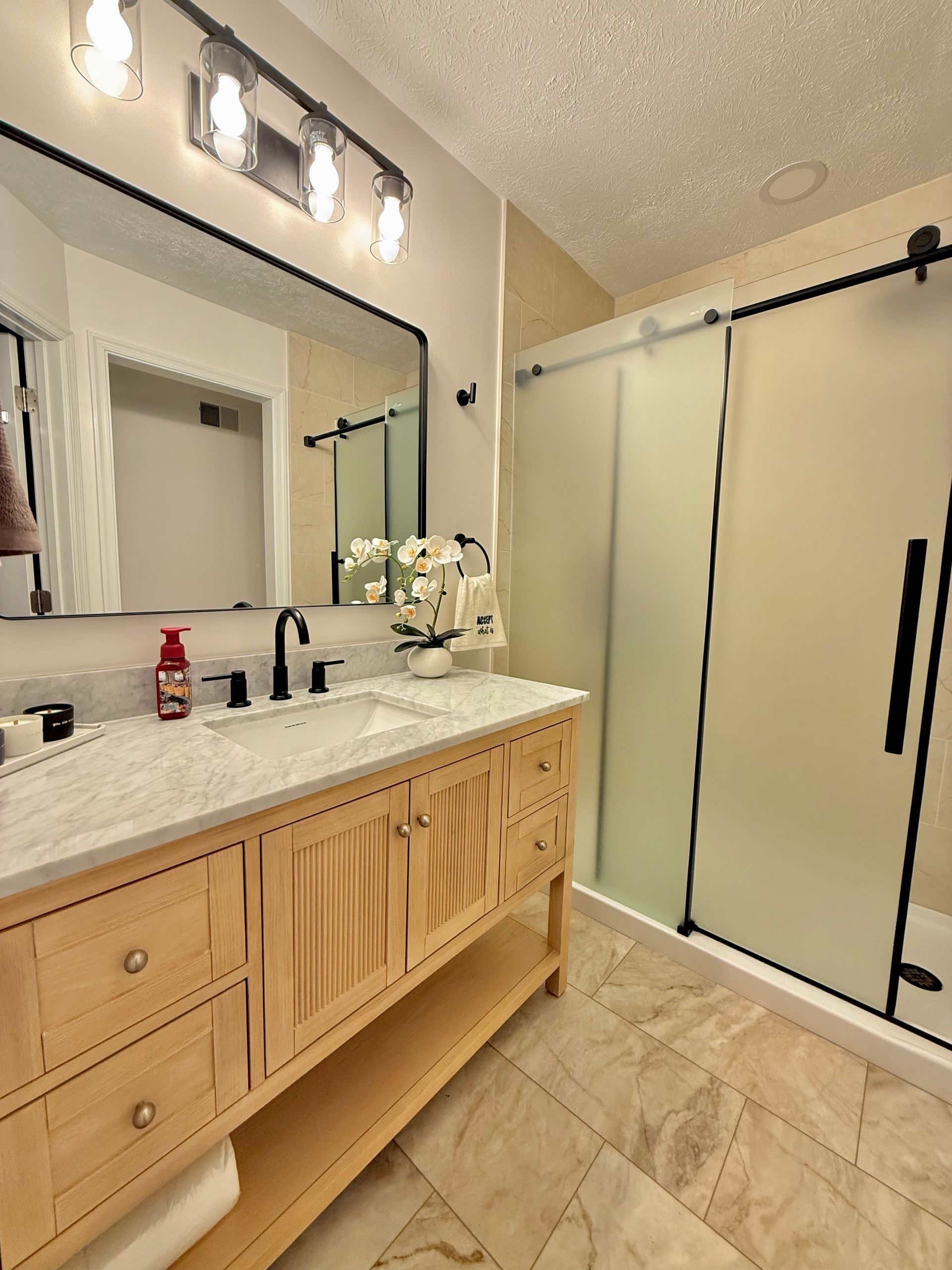 Owings Mills Bathroom Remodel: Professional installation of natural wood vanity with marble countert