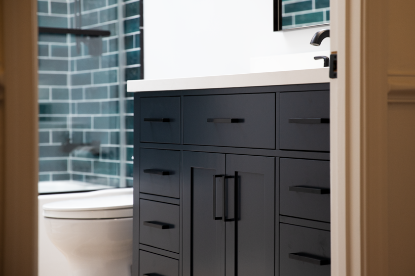 Modern bathroom renovation with new vanity, fixtures, and a skylight for natural light.