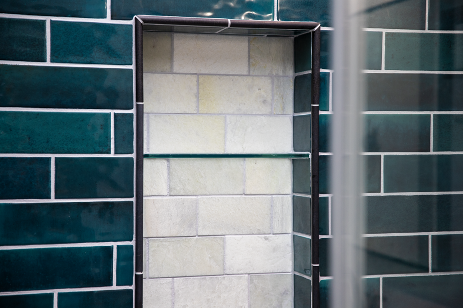 Contemporary bathroom update with vibrant tile and stylish dark hardware.