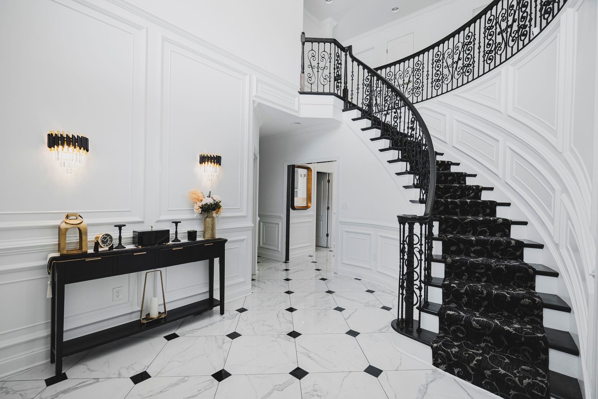 Modern foyer remodel in Owings Mills: custom staircase refinishing, metal balusters, and marble tile