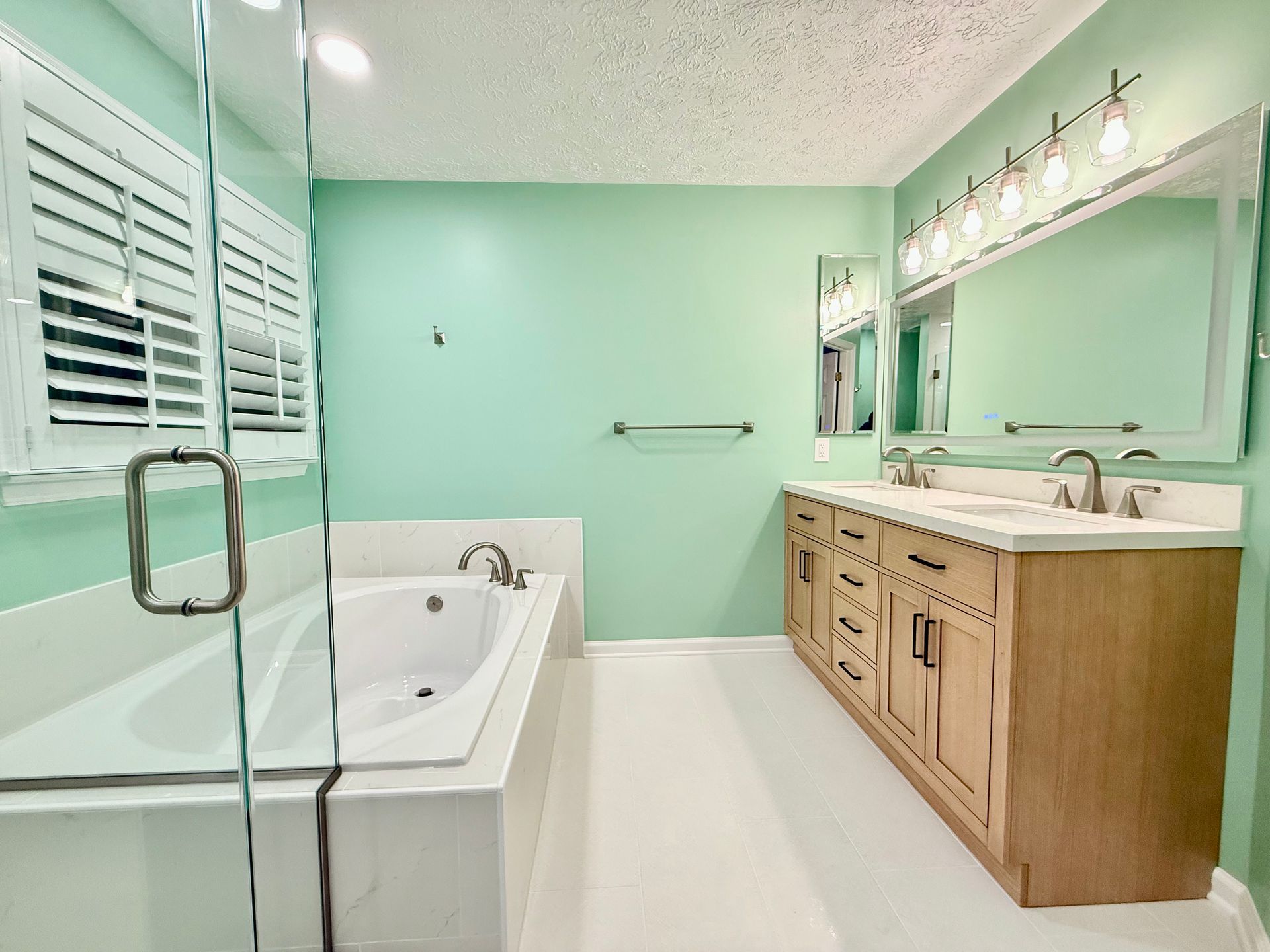 Professional plumbing and tile work demonstrated on the installed soaking tub and adjacent shower