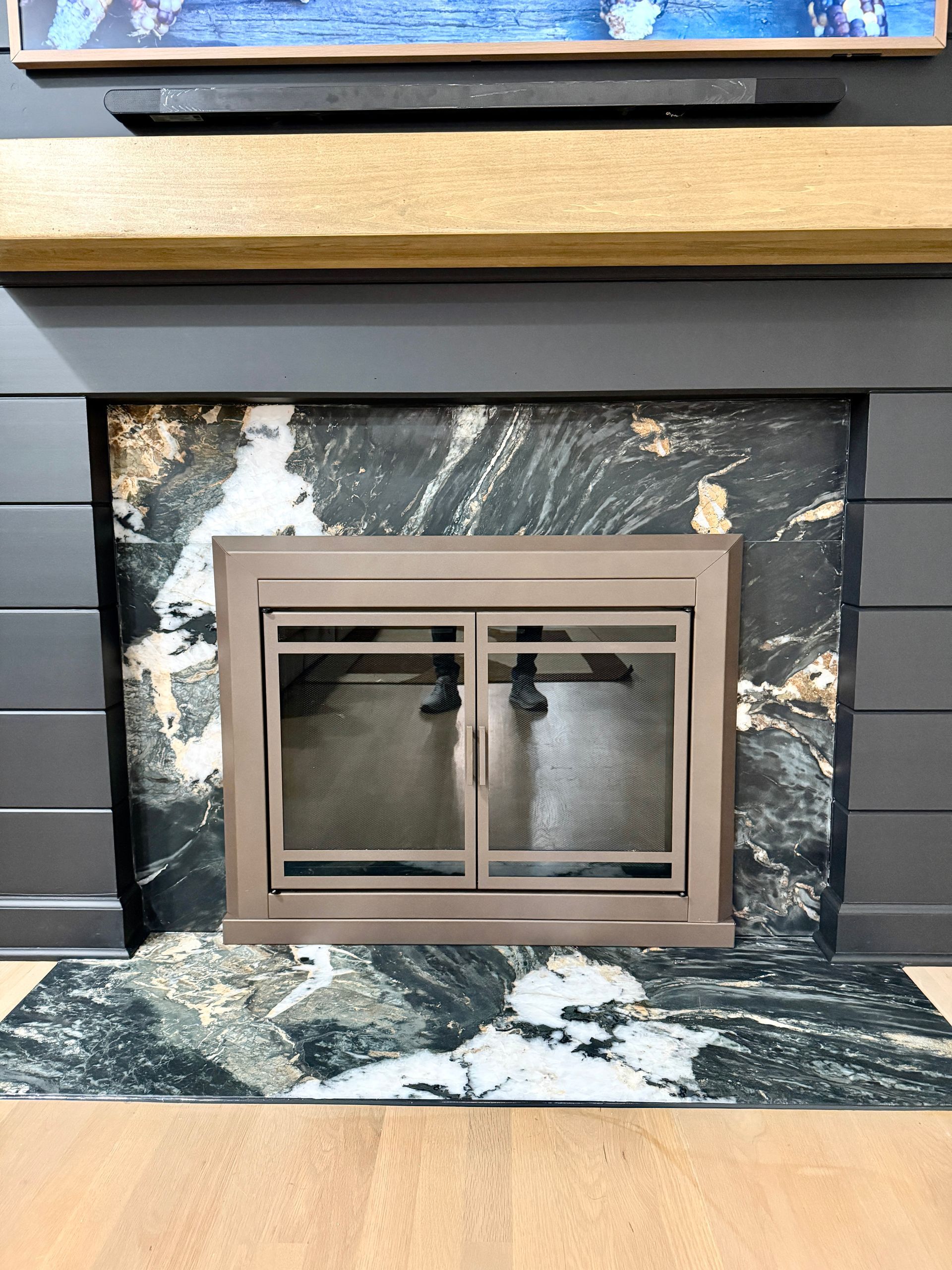 Precision stone installation: natural marble fireplace surround detailing around firebox insert.