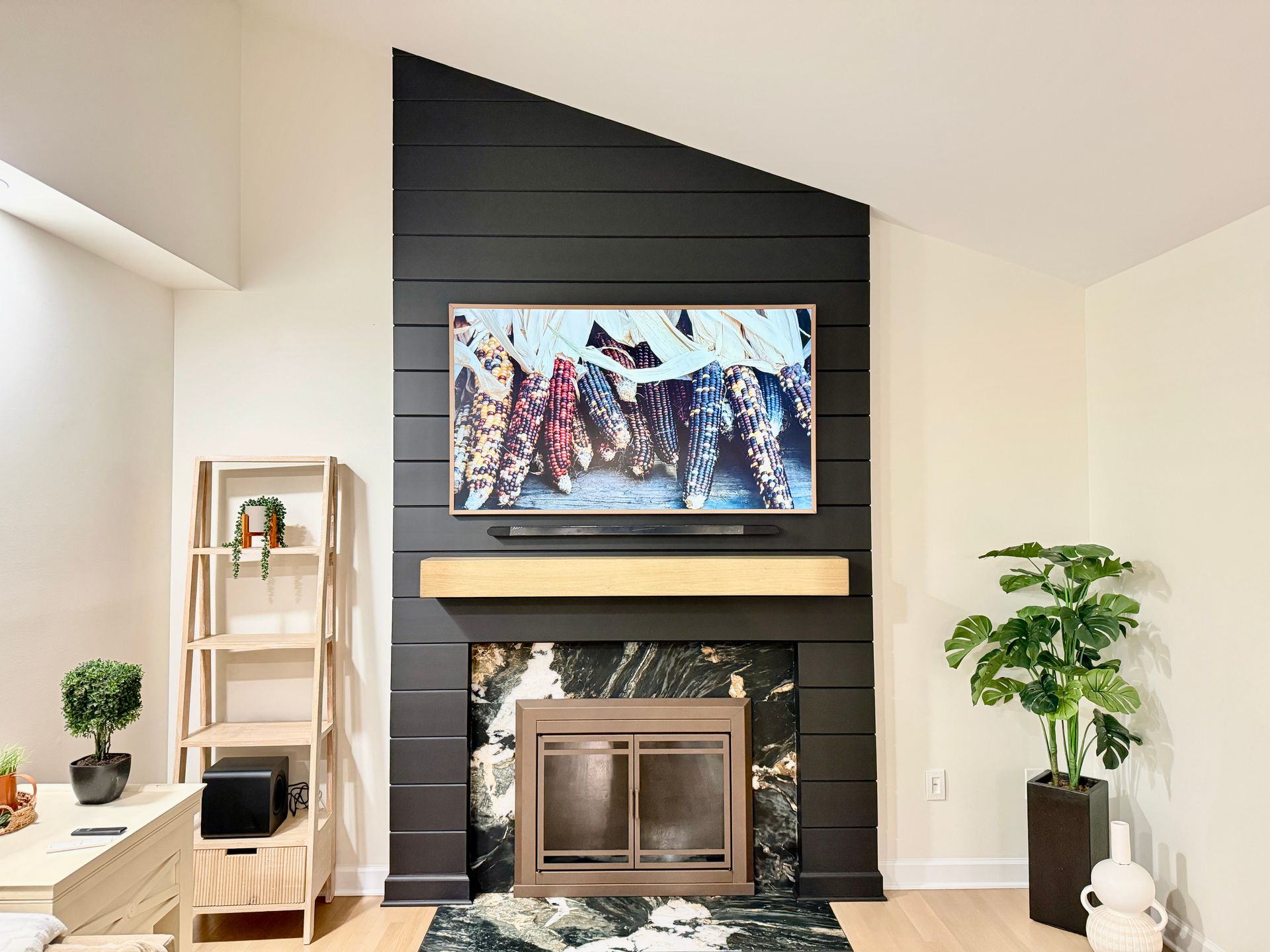 Custom-scaled wood fireplace mantel and modern accent wall carpentry by A1 Renovations in Maryland.