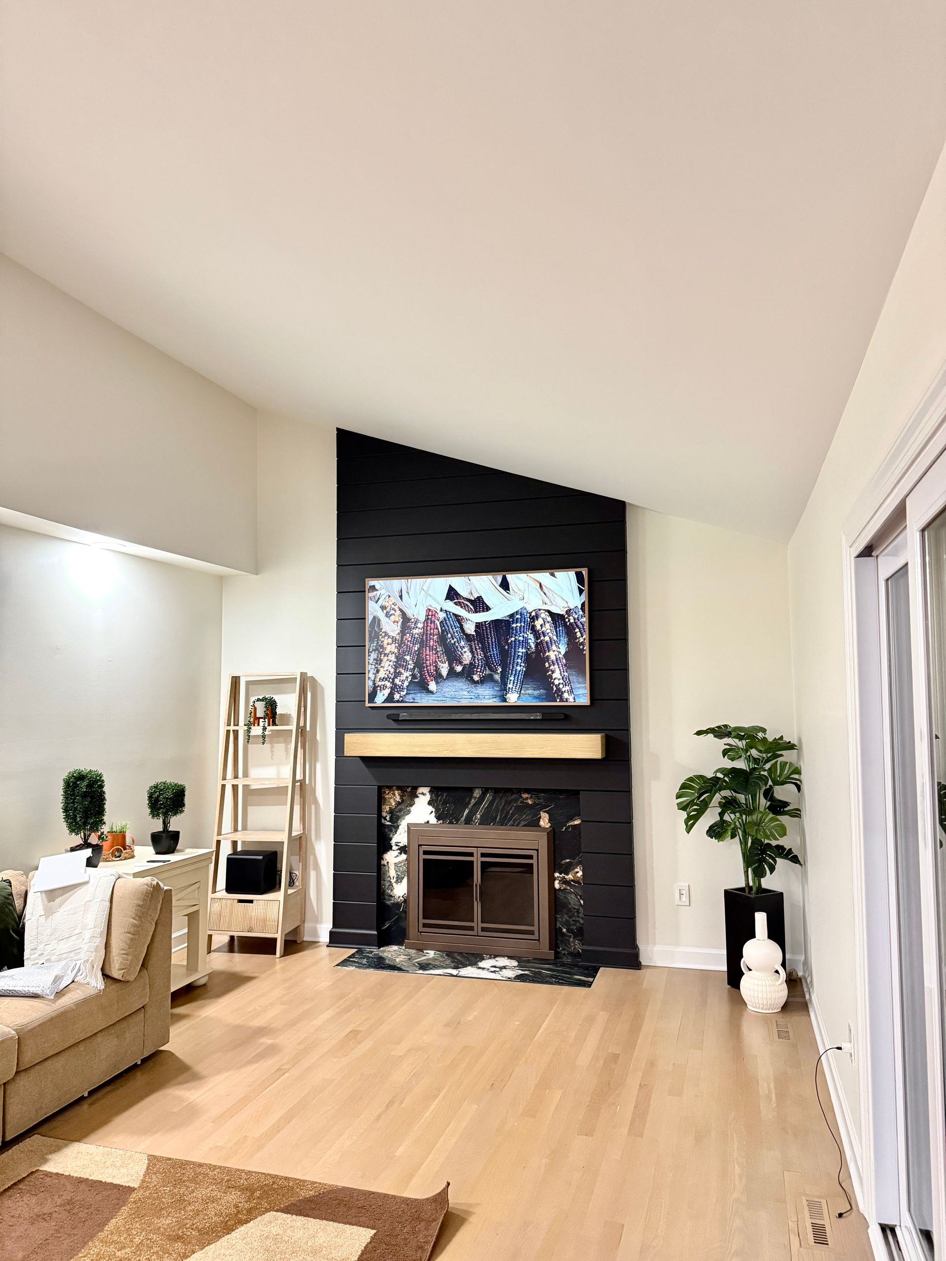 Monkton MD contractor's custom black shiplap media wall and fireplace surround installation.