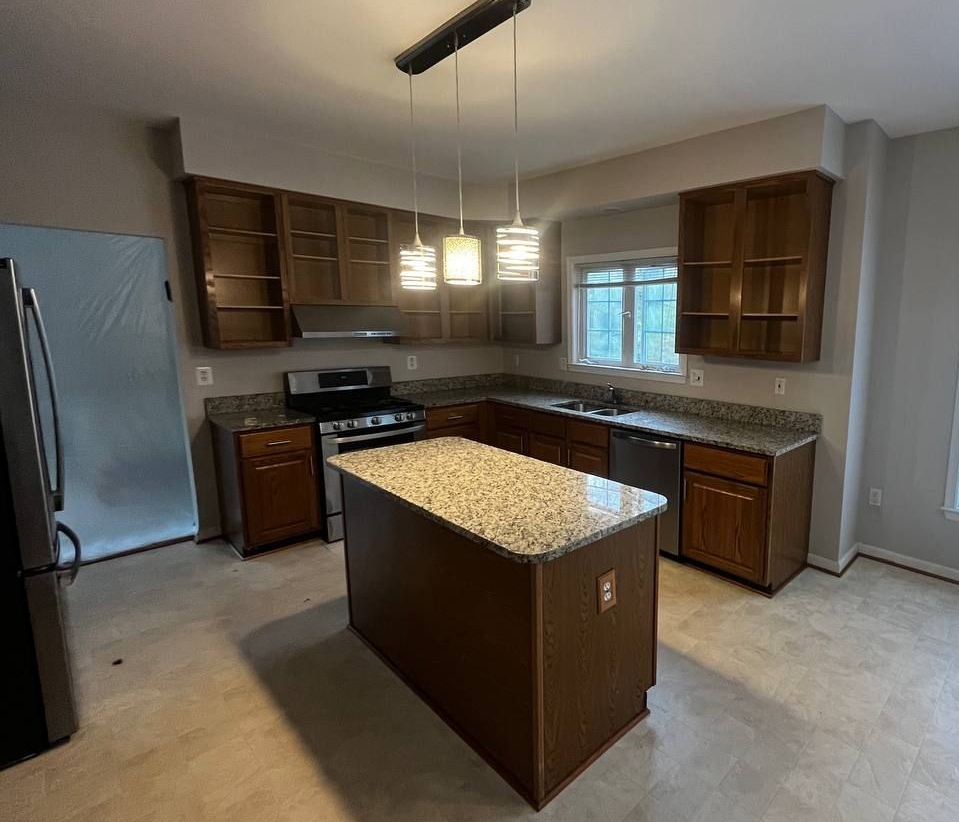 Before photo of a Timonium kitchen remodel showing dated 1990s builder-grade honey oak cabinets.