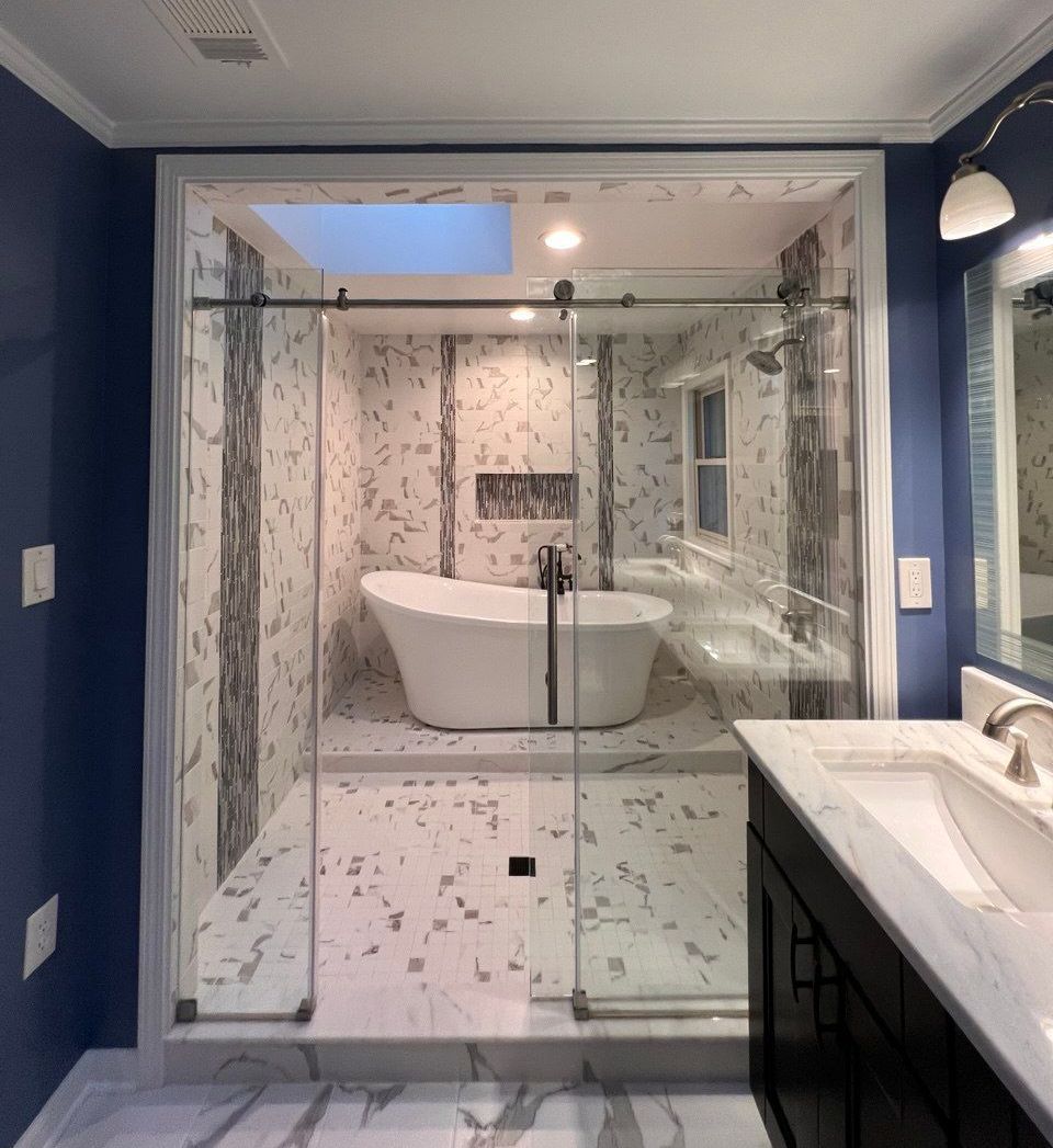 Modern master bathroom remodel with a freestanding tub seamlessly integrated into the shower space in Greater Baltimore, MD