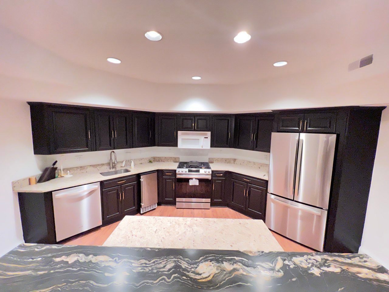 Modern kitchen remodeling with dark cabinets, stainless steel appliances, and granite countertops In Eldersburg, MD