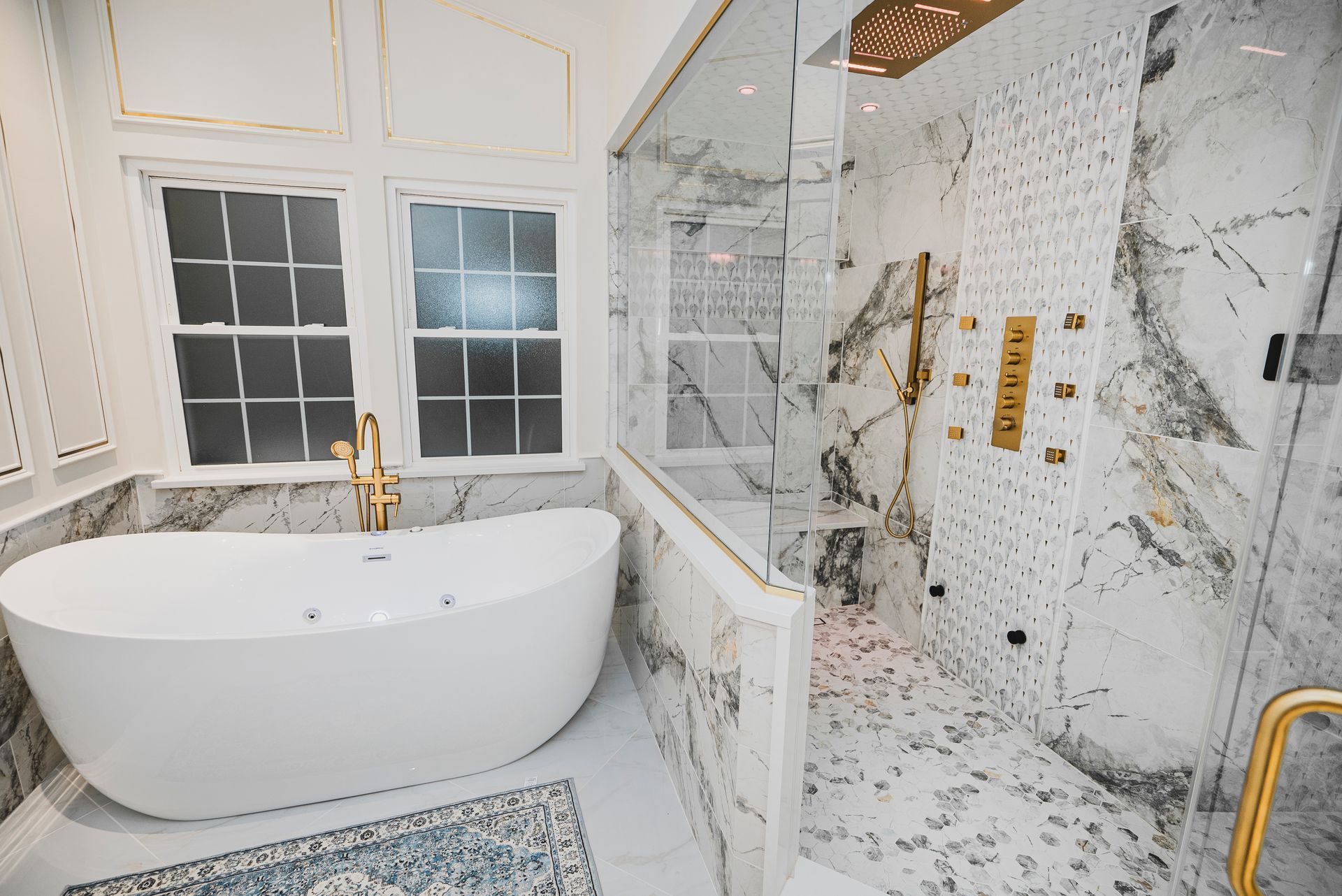 Structural renovation removing interior walls to create an open-concept luxury bathroom.
