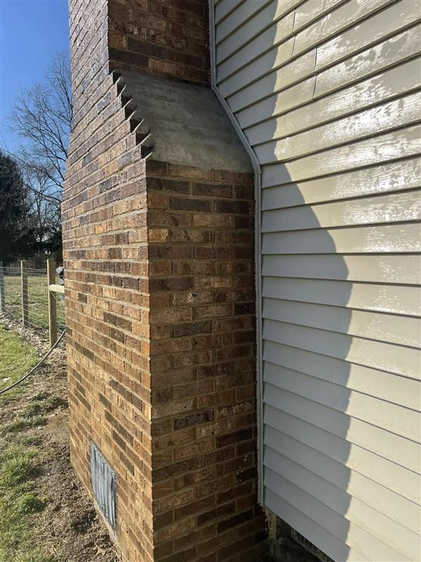A person uses a string to measure brickwork against a white wall; interior construction. A person uses a string to measure brickwork against a white wall; interior construction.