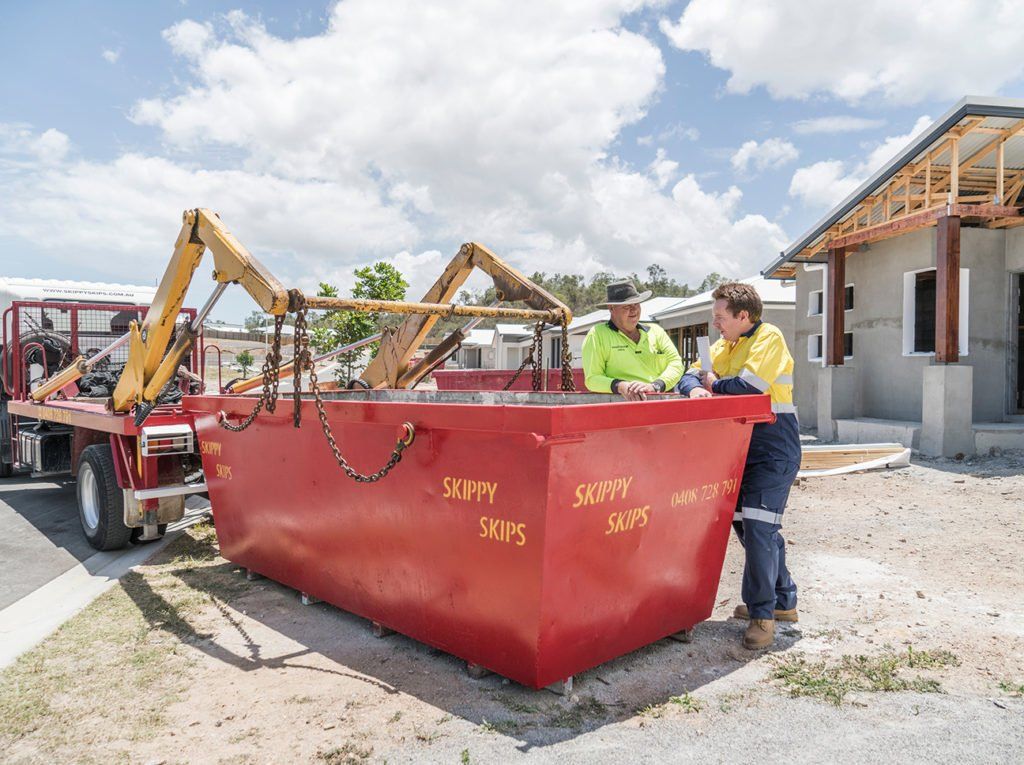 Two People Beside Crane Lift Truck — Garbutt, QLD – Skippy Skips