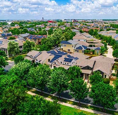 An aerial view of a residential area with lots of houses and trees.