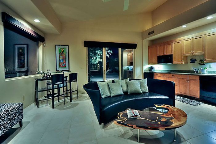 A living room with a curved couch and a coffee table