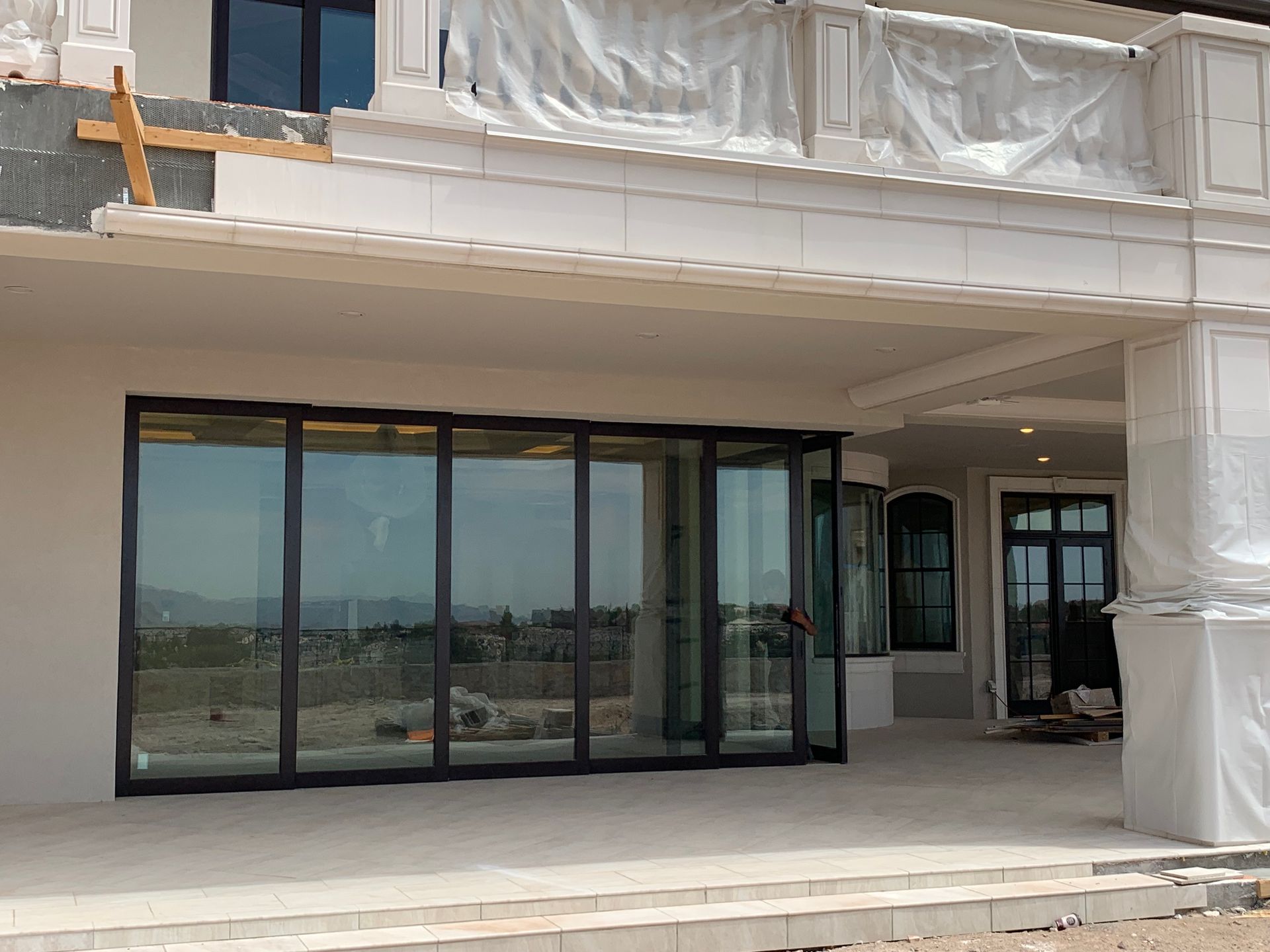 A large house with a lot of windows is being built.