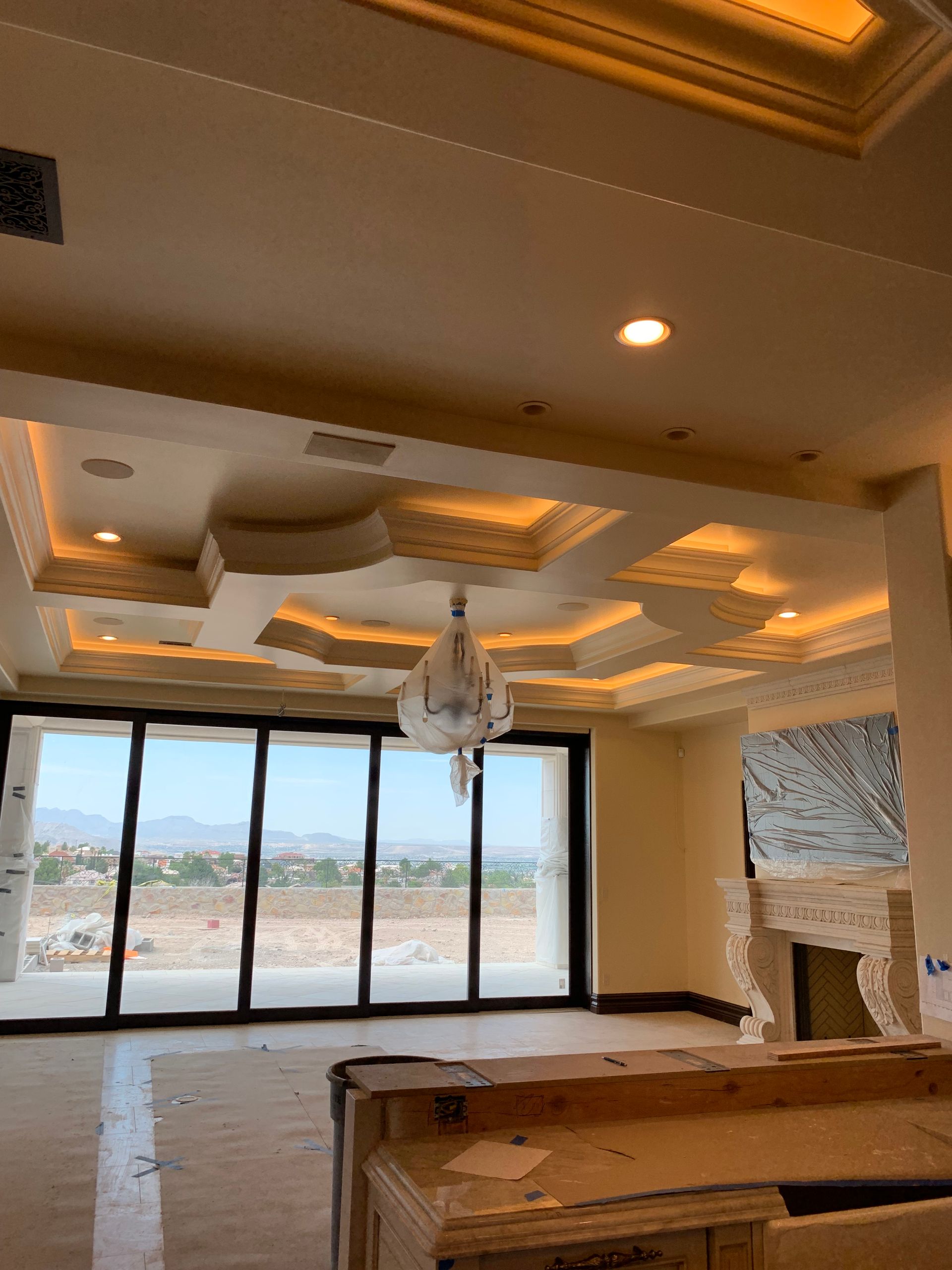 A large empty room with a chandelier hanging from the ceiling