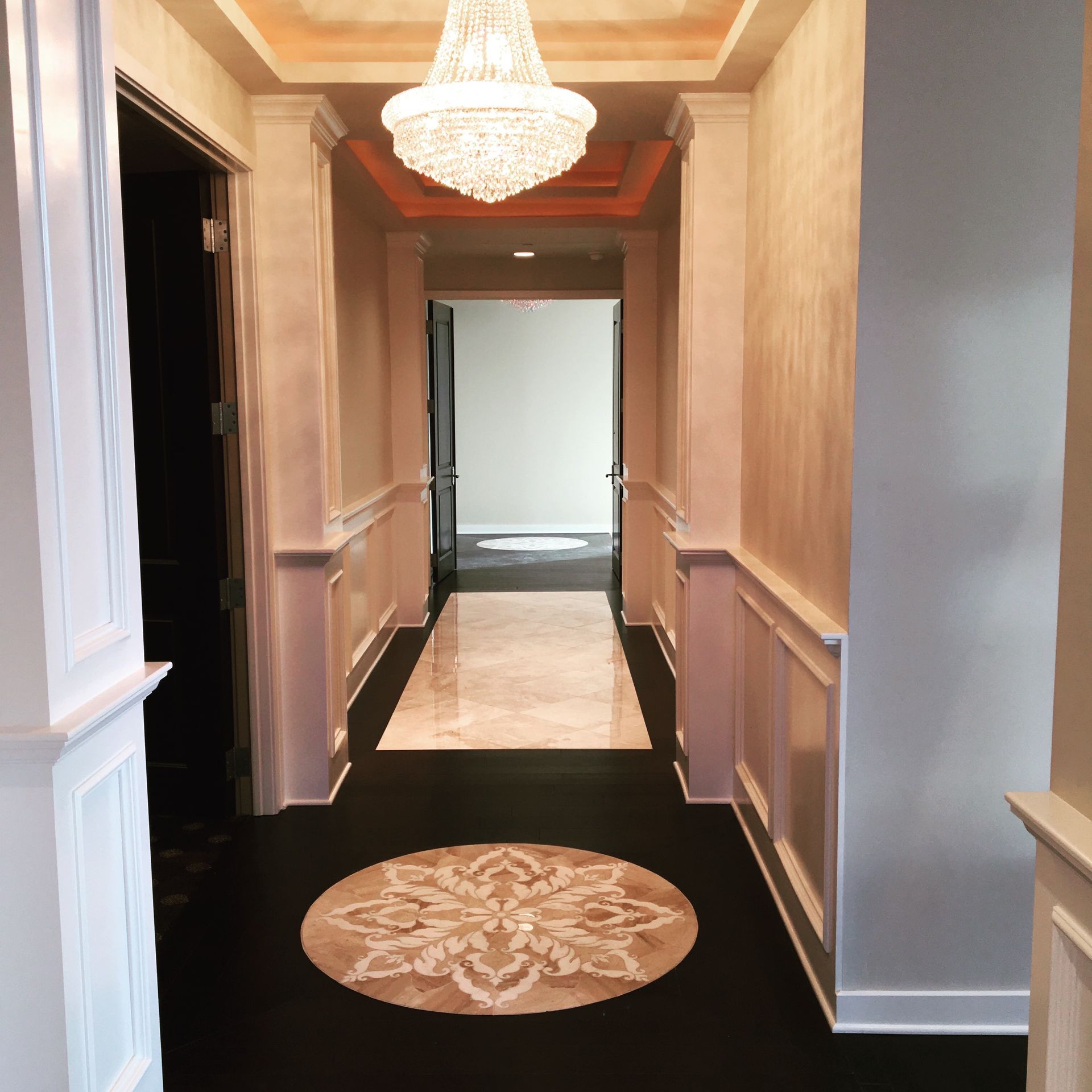 A hallway with a chandelier hanging from the ceiling