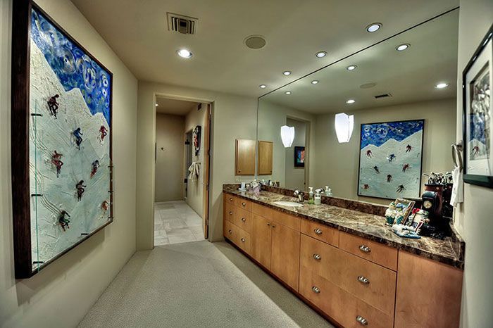 A bathroom with two sinks and a large mirror.