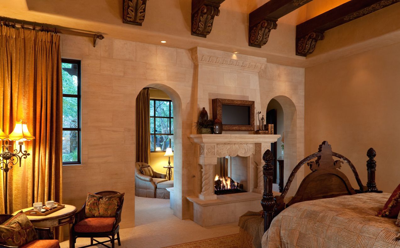 A bedroom with a fireplace and a bed
