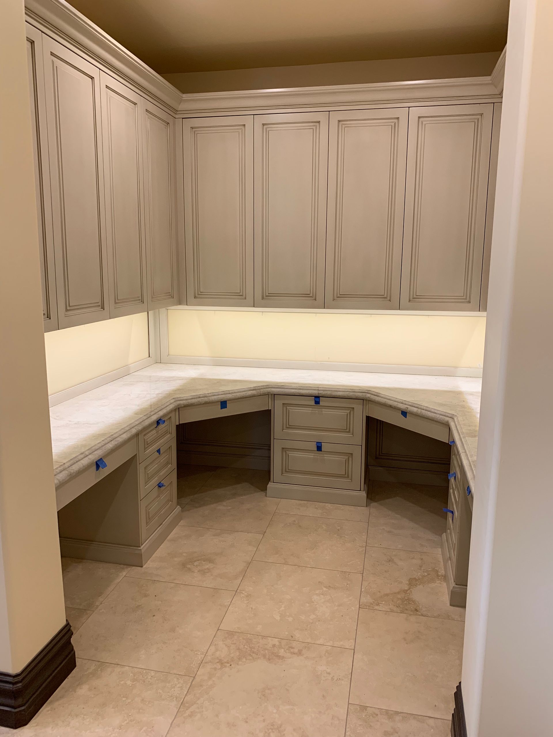 A room with a lot of cabinets and drawers in it.