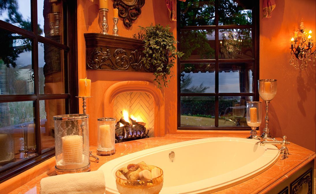 A bathroom with a fireplace and a bathtub.