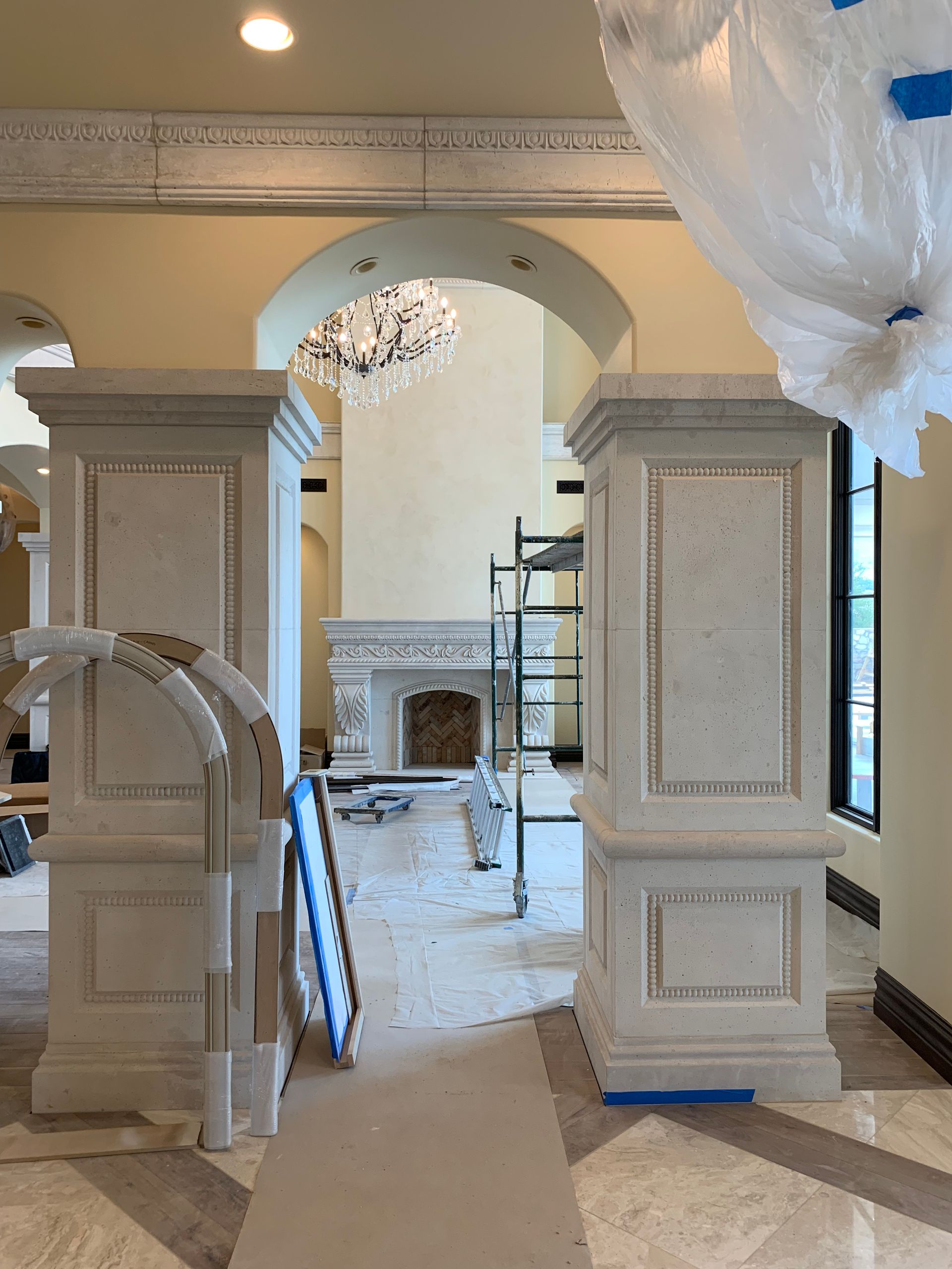 A room with columns and a fireplace in it