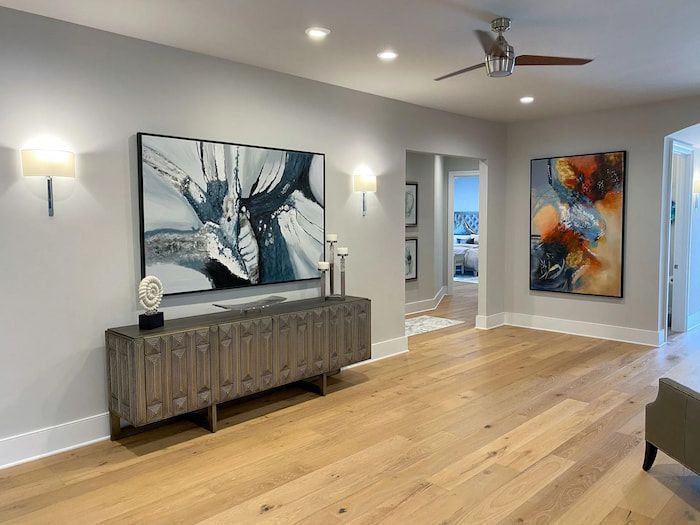 A living room with hardwood floors and a ceiling fan.