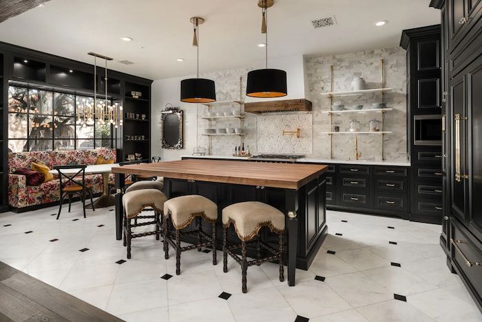 luxury kitchen with black cabinets and wooden countertop