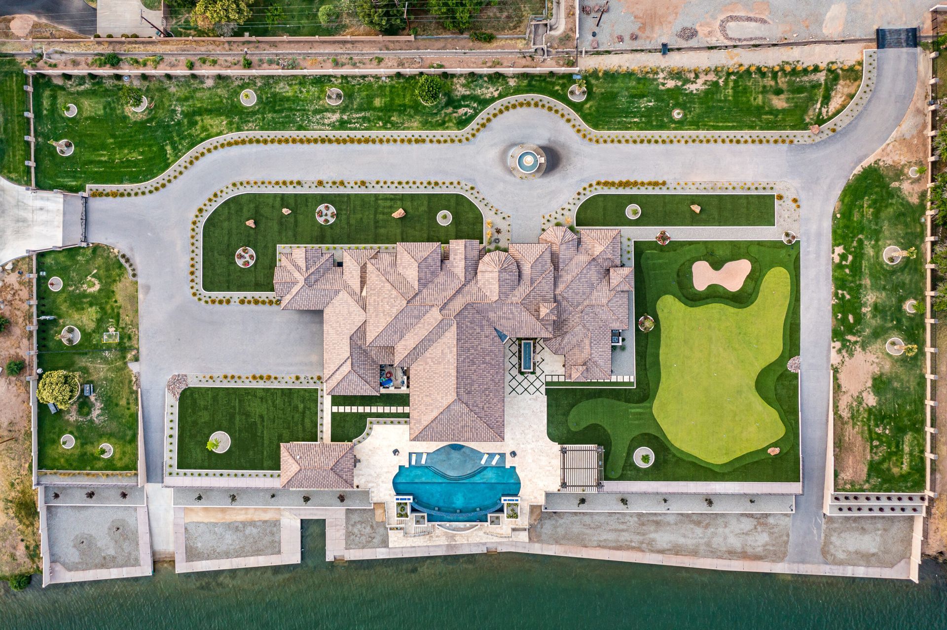 An aerial view of a large house with a golf course