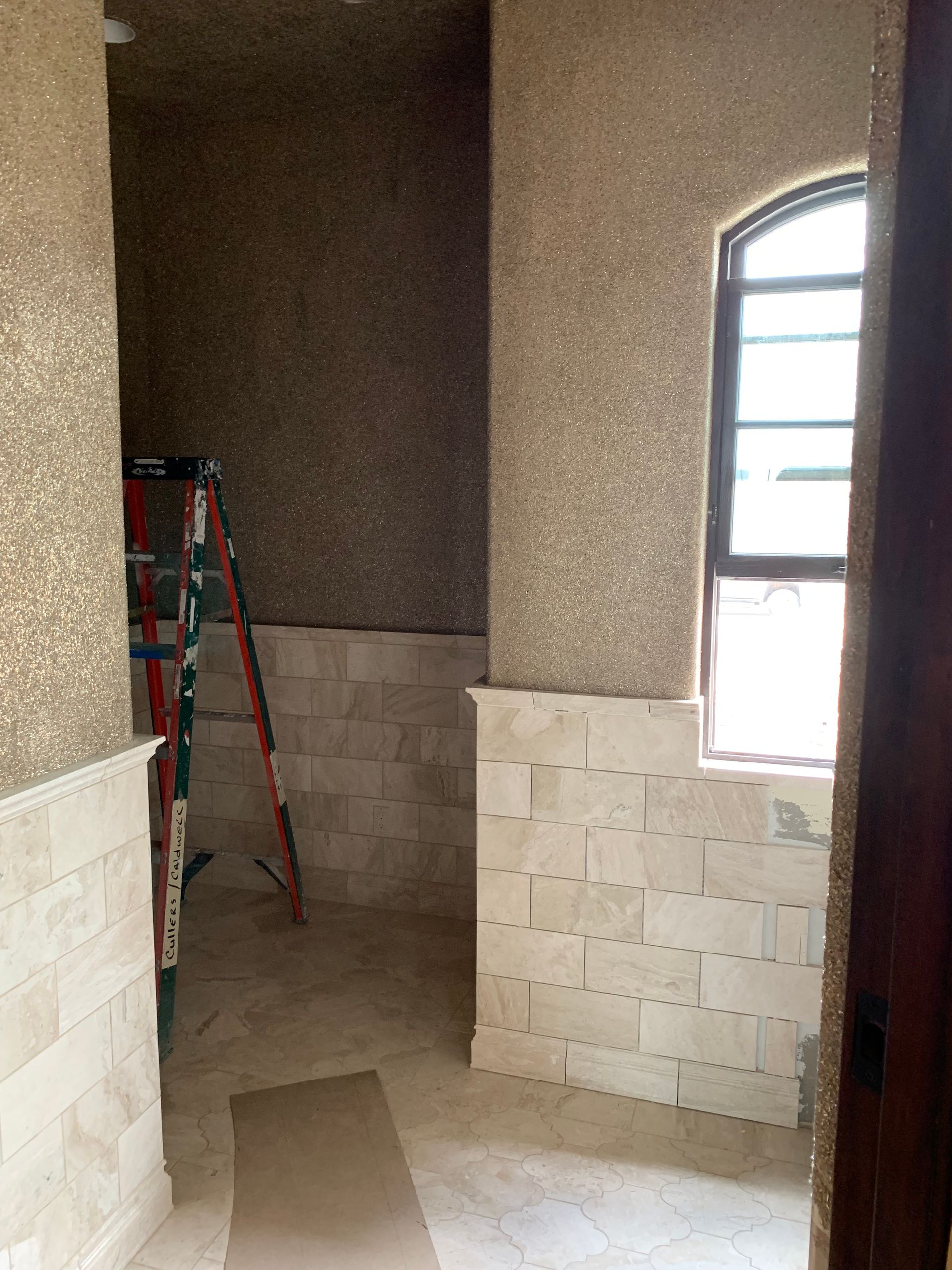 A room with a window and a ladder in it