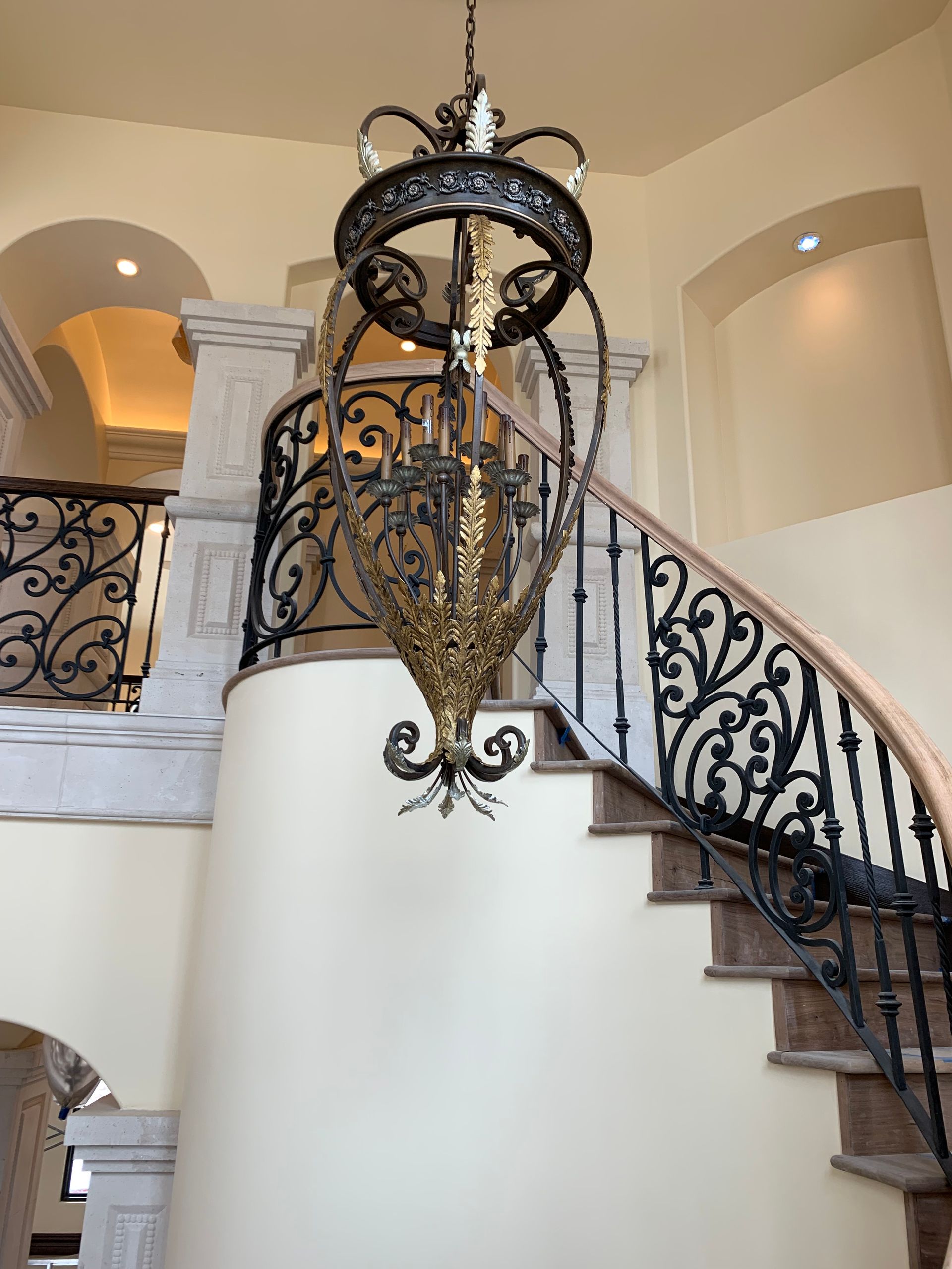 A staircase with a chandelier hanging from the ceiling