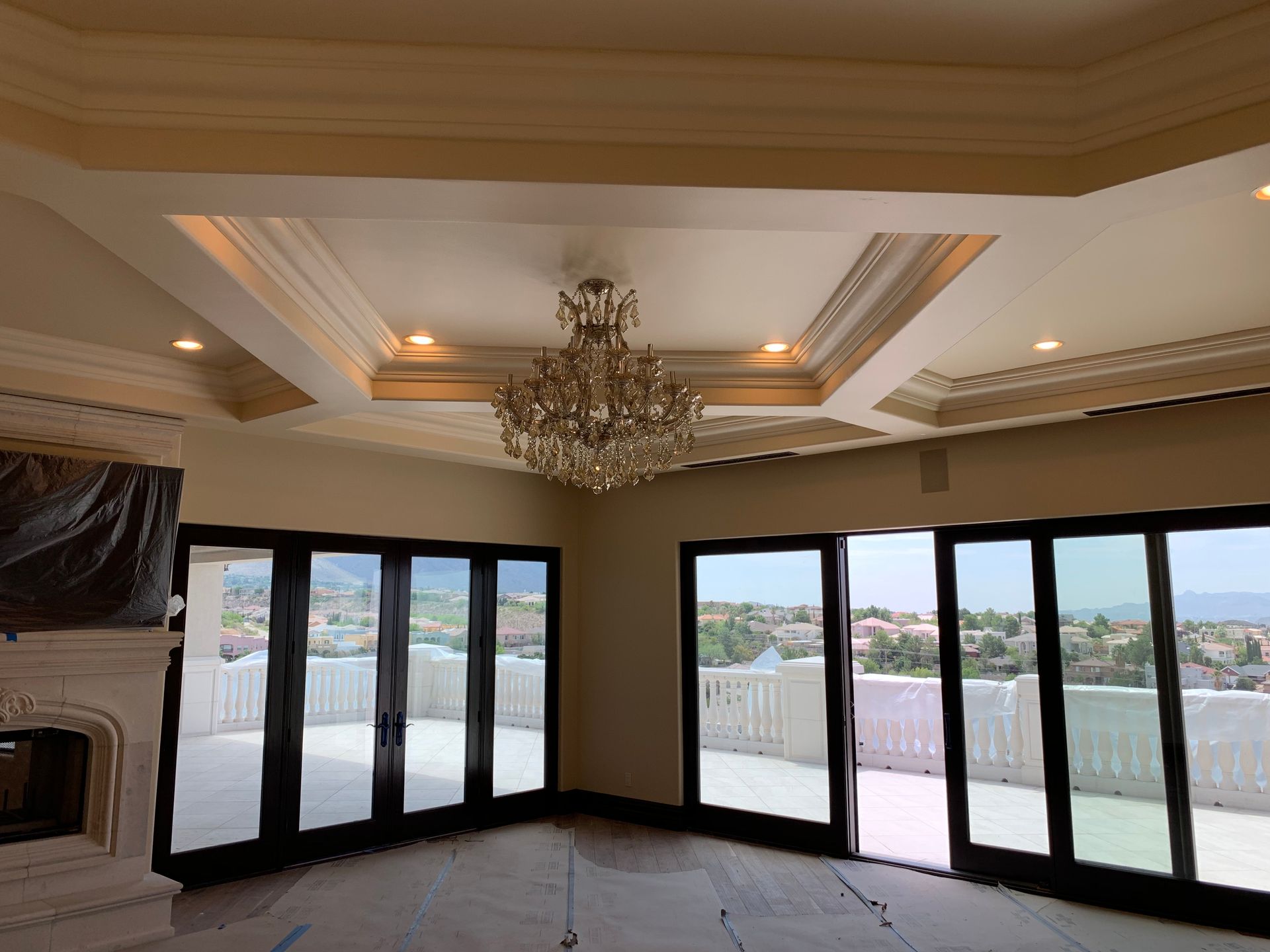 A living room with a chandelier and lots of windows