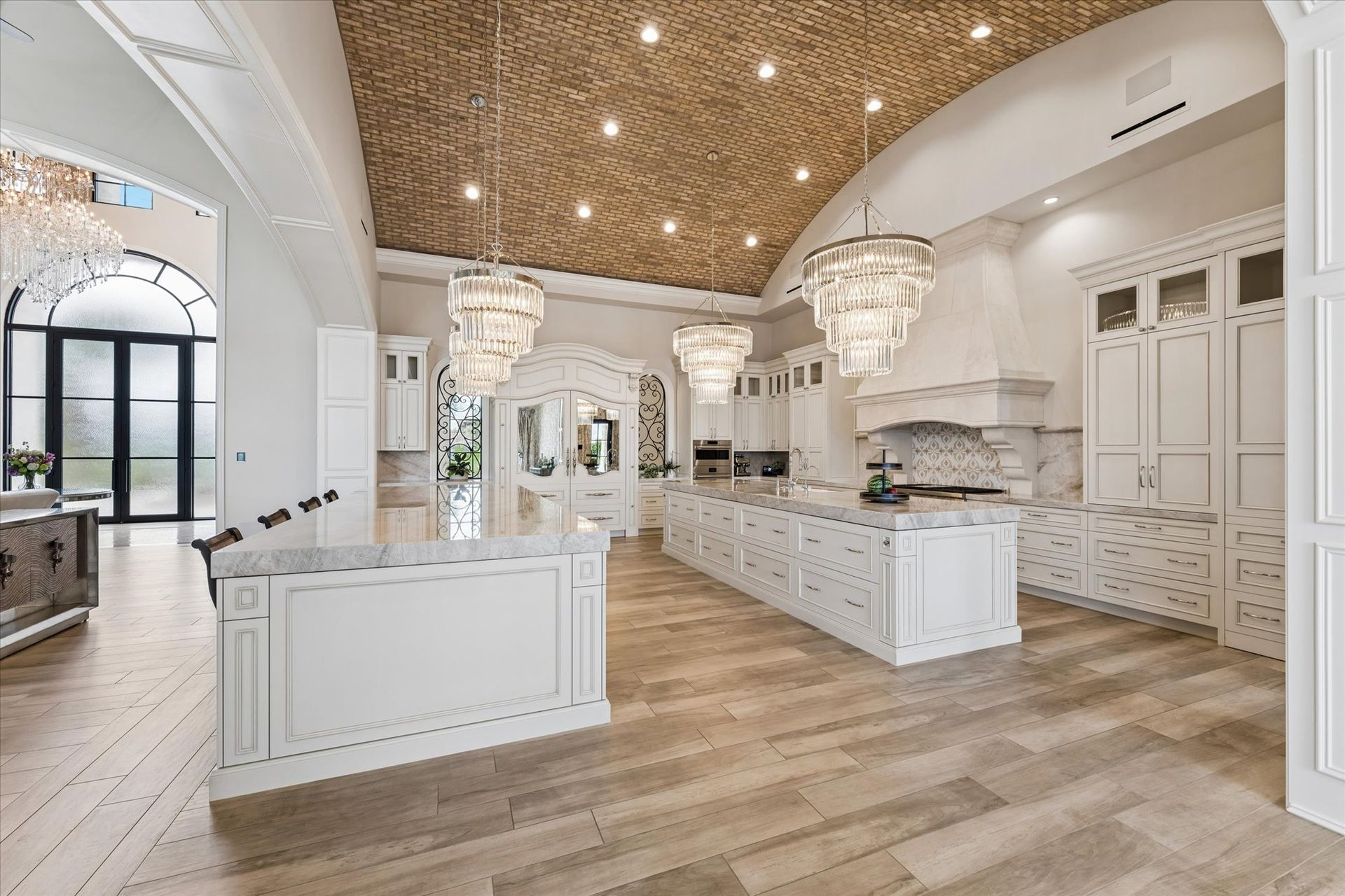 Fratantoni custom luxury kitchen with hidden fridge, dual islands and brick ceiling