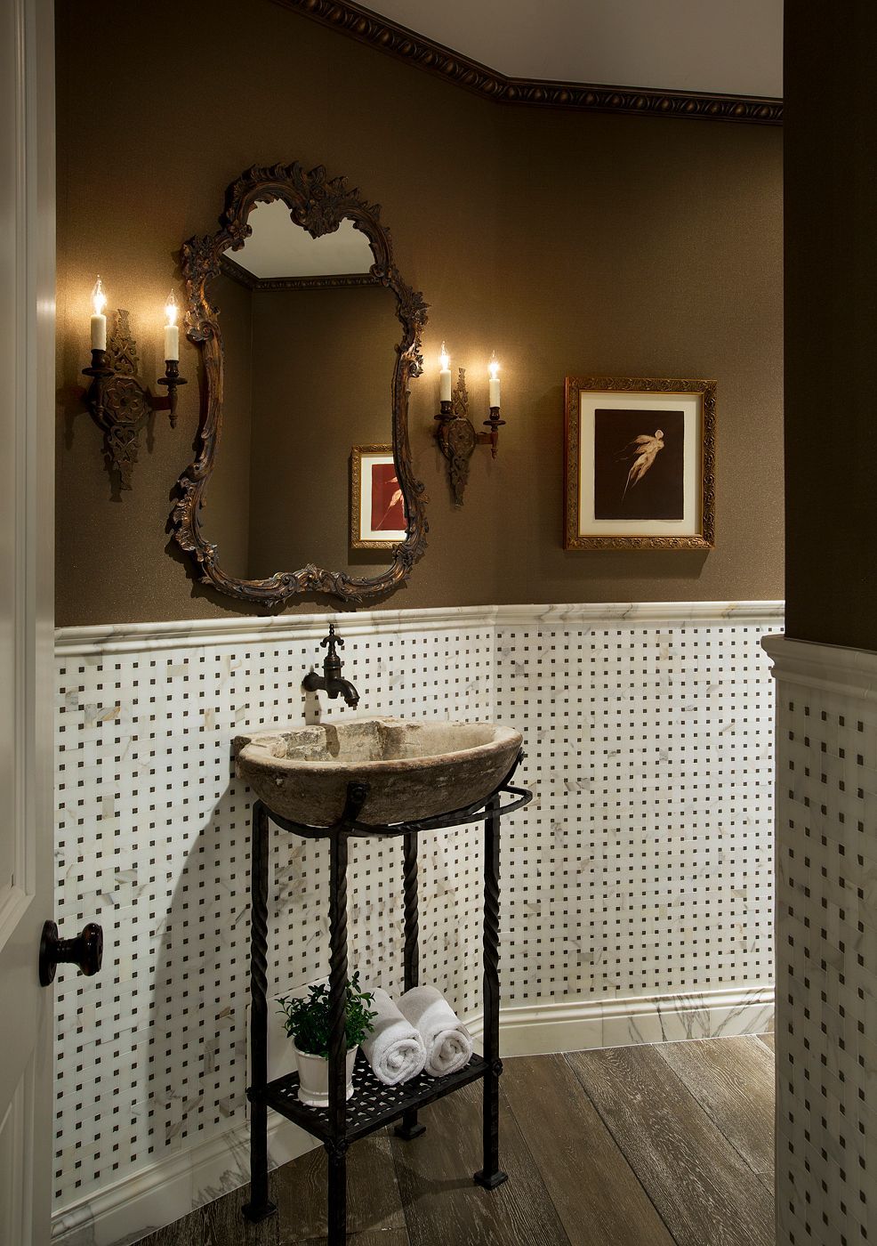 A bathroom with a sink a mirror and candles