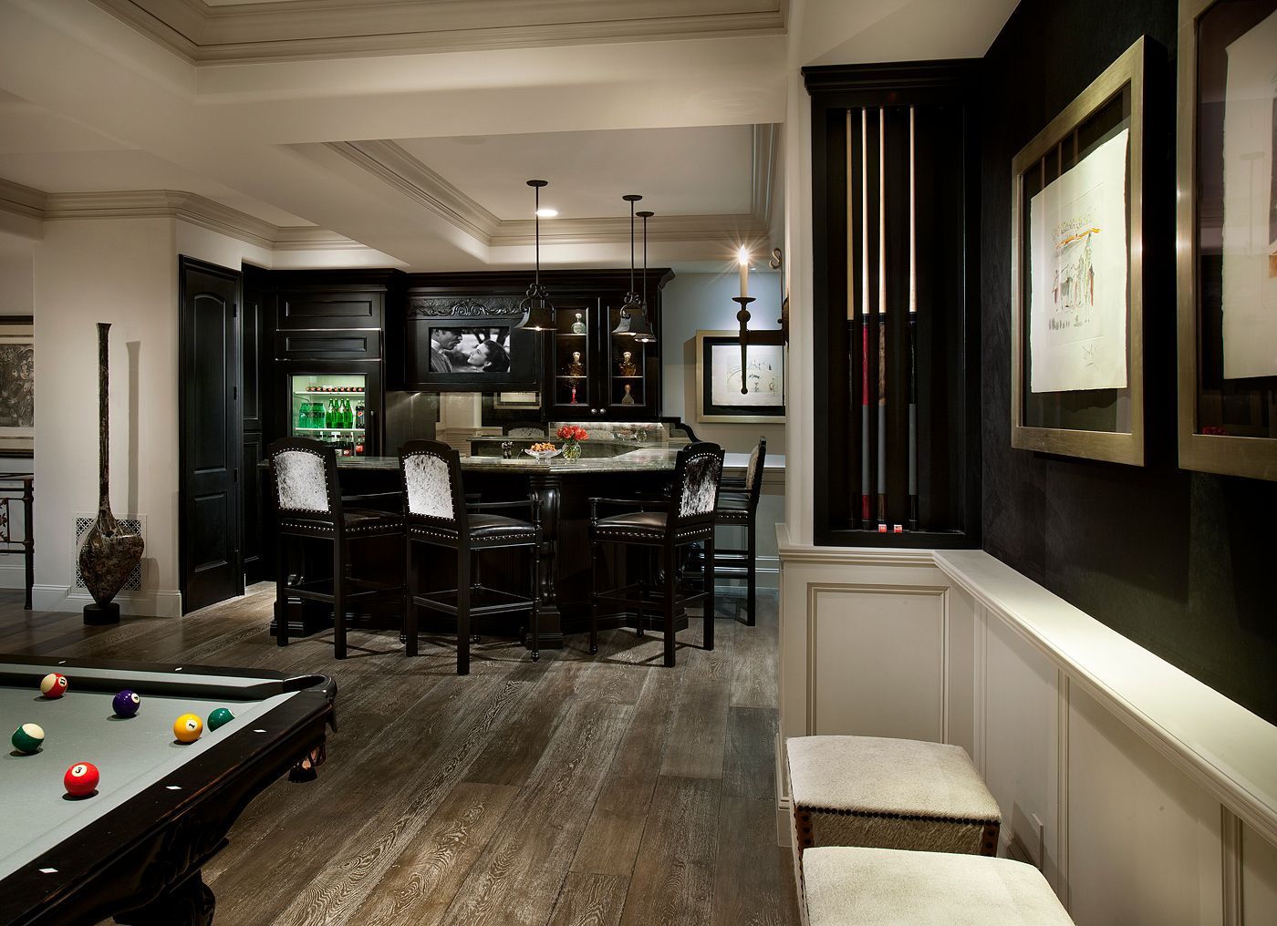 A game room with a pool table and a bar