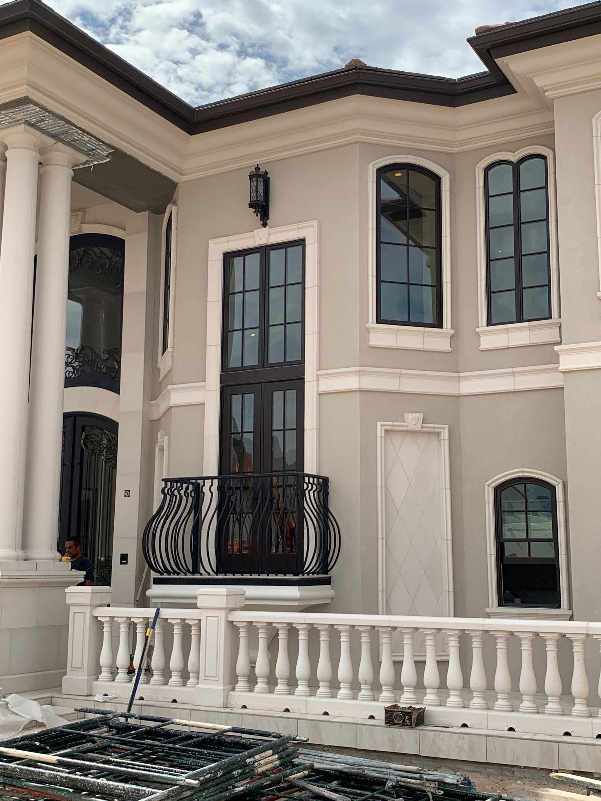 A large white house with a balcony and a lot of windows.
