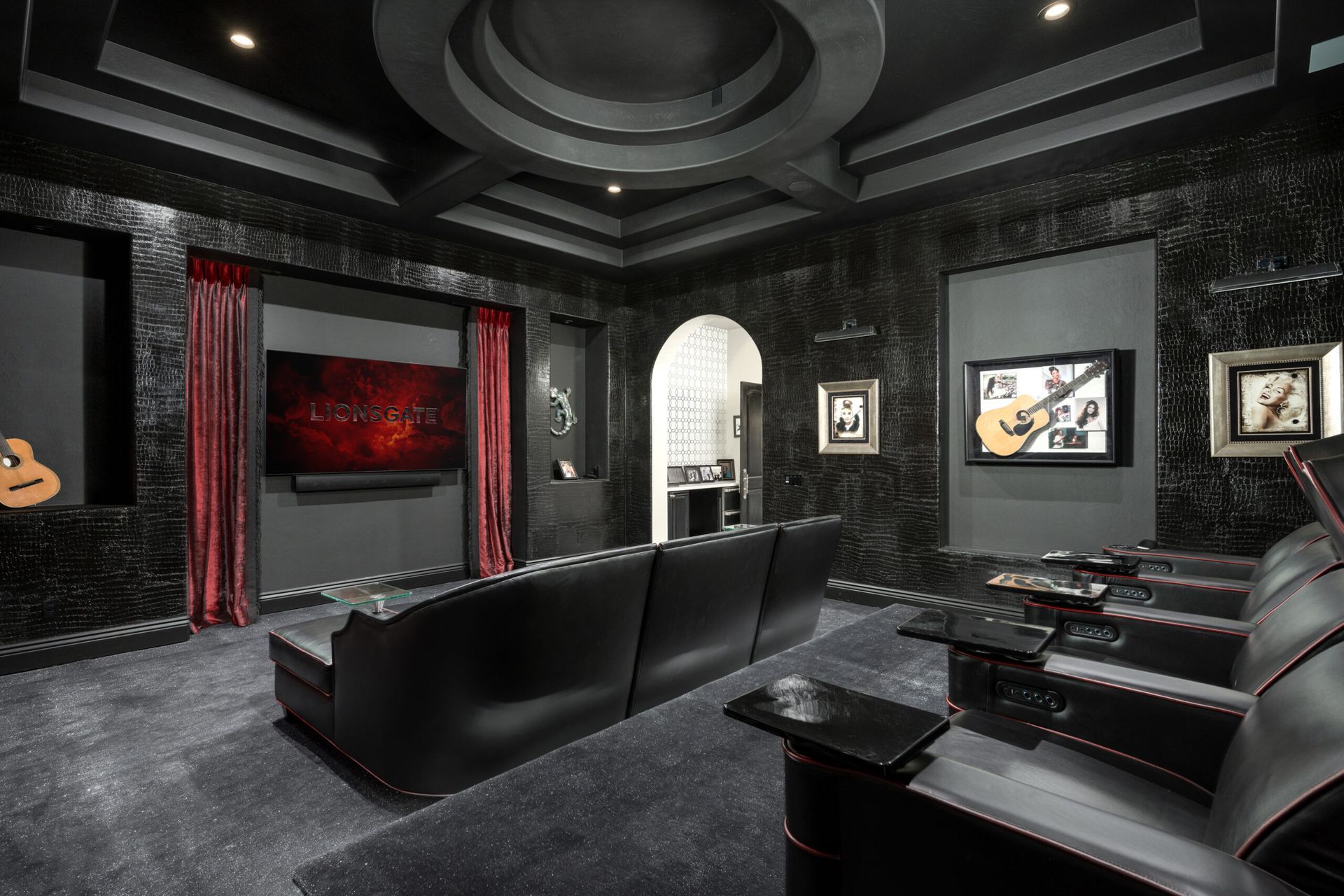A living room with black furniture and a flat screen tv