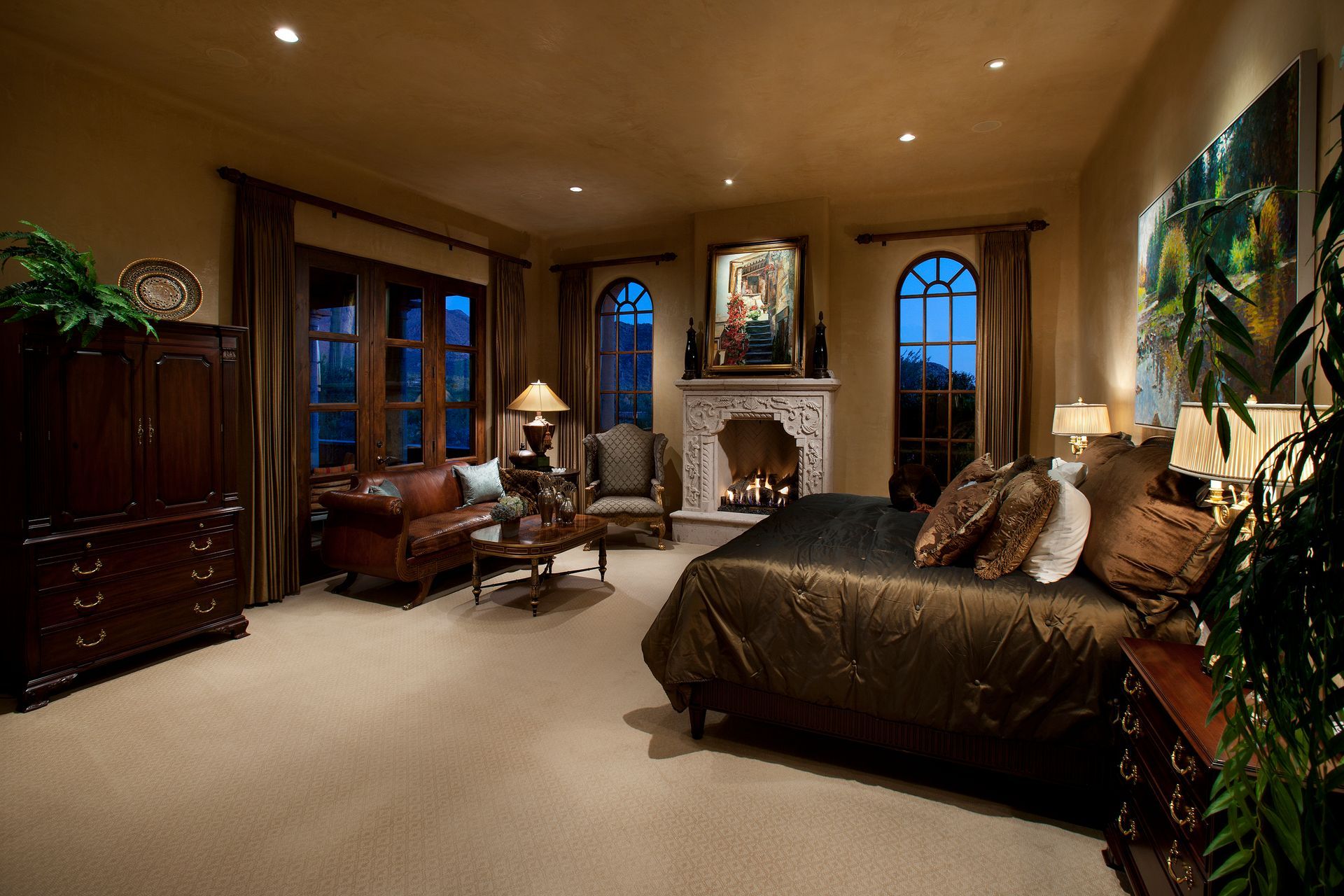 A bedroom with a large bed and a fireplace