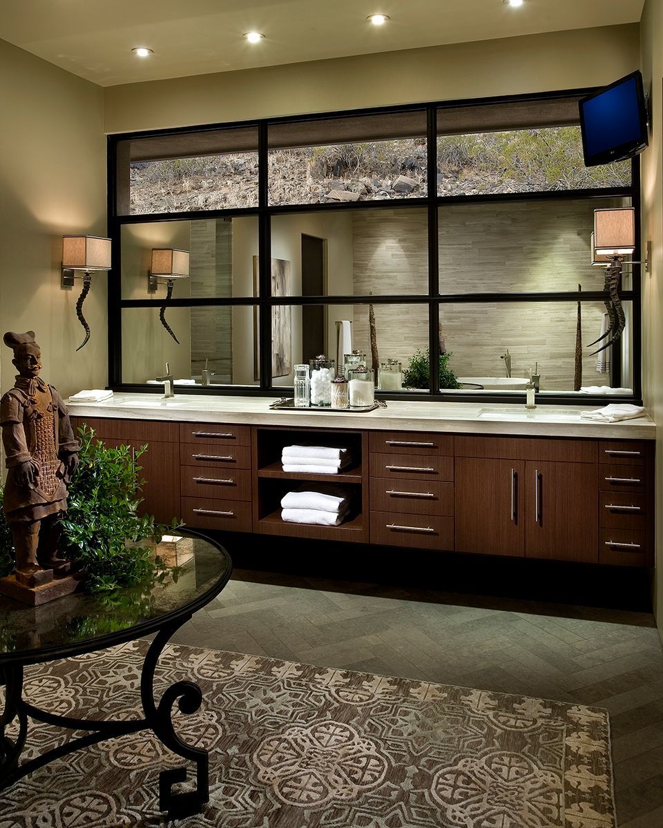 A bathroom with two sinks and a large mirror