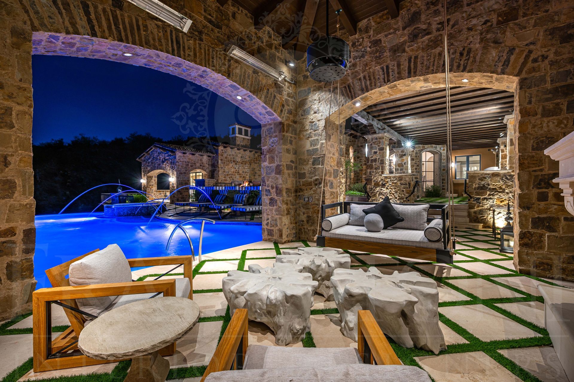 Luxury French patio design with pool, custom furniture and stone arches
