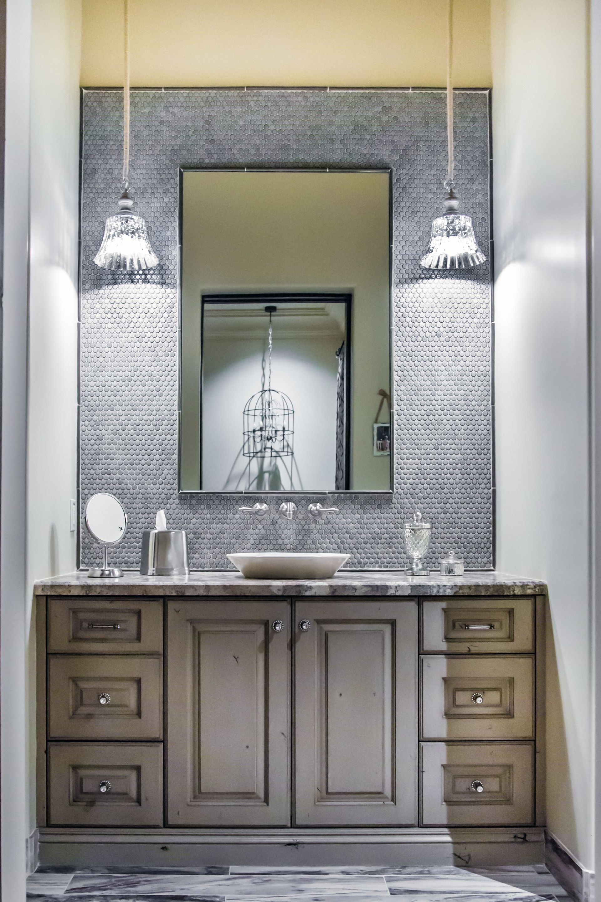 A bathroom with a sink , mirror and drawers