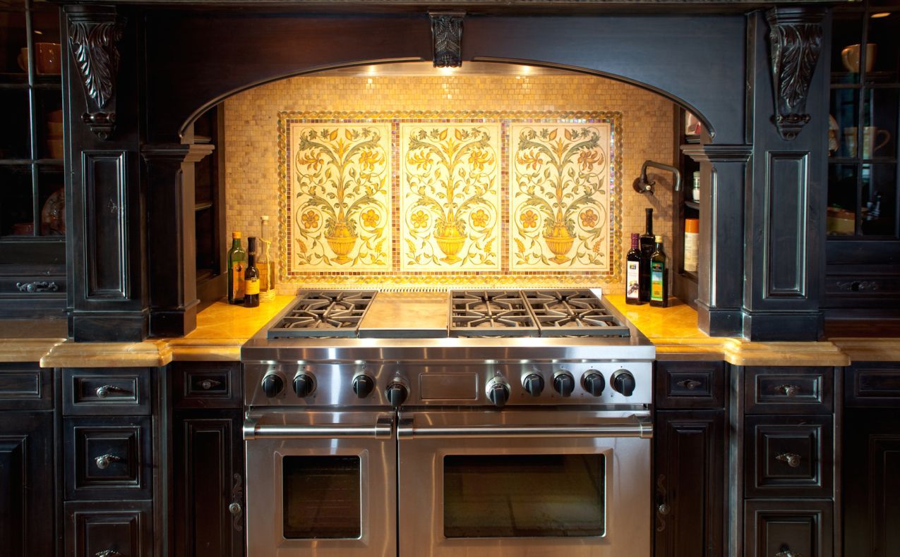 A kitchen with a stove top oven and a hood