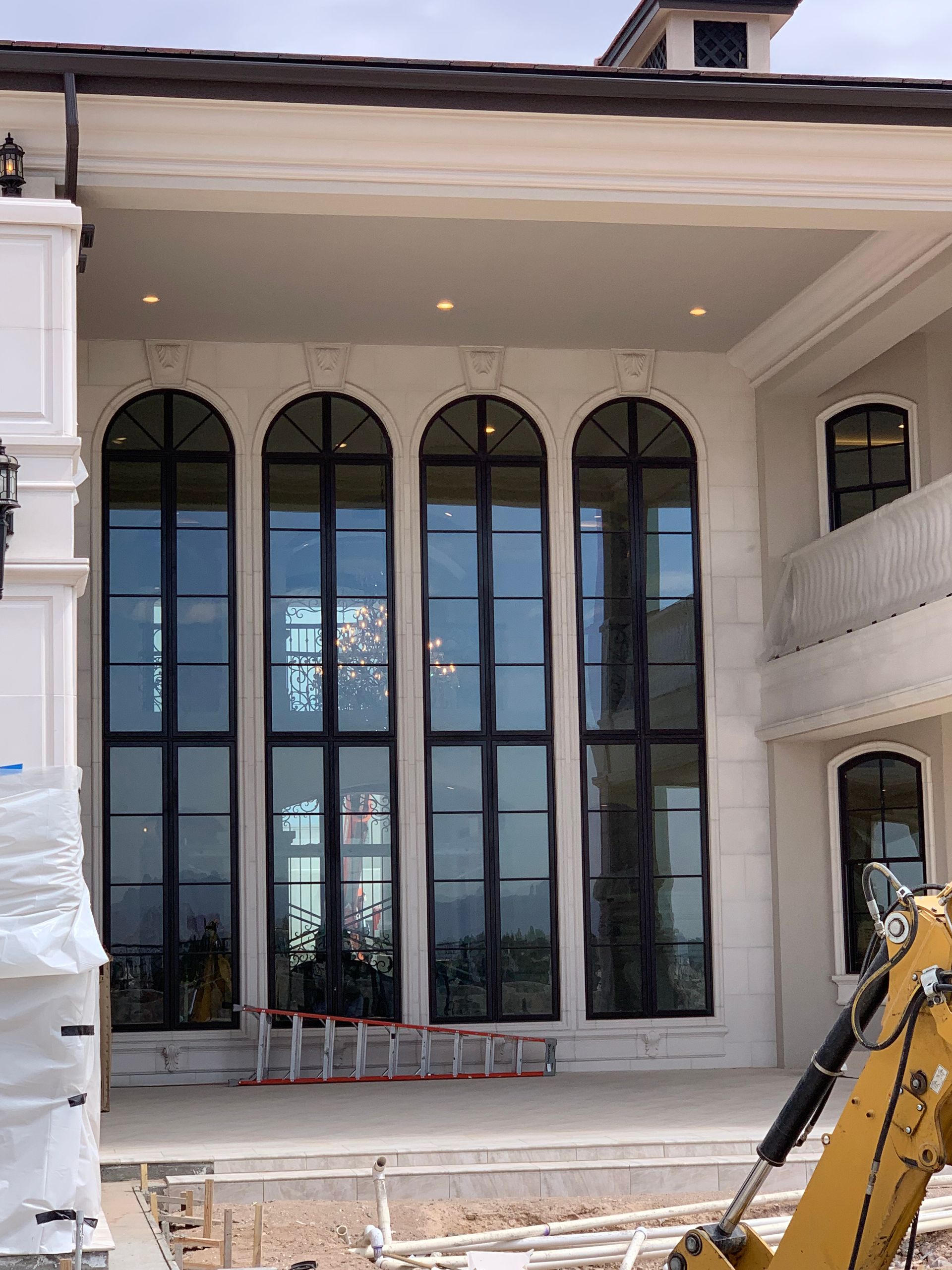 A large house with a lot of windows is being built.