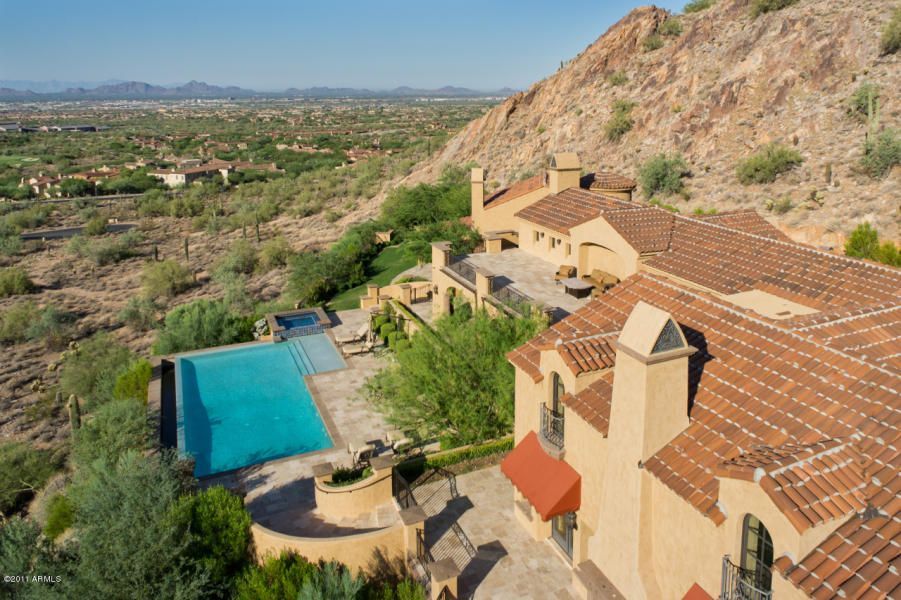 An aerial view of a large house with a swimming pool