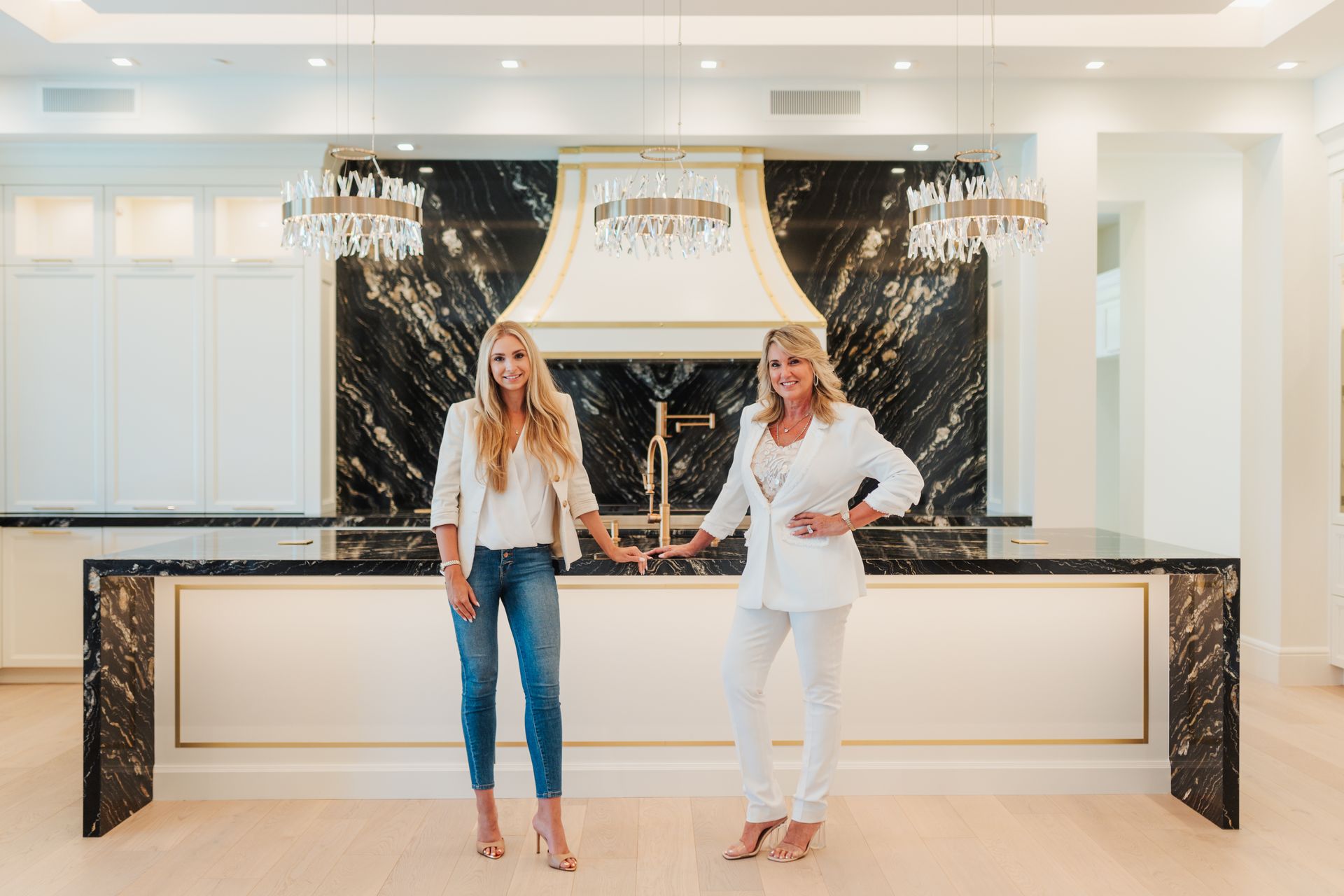 two women standing in a modern kitchen