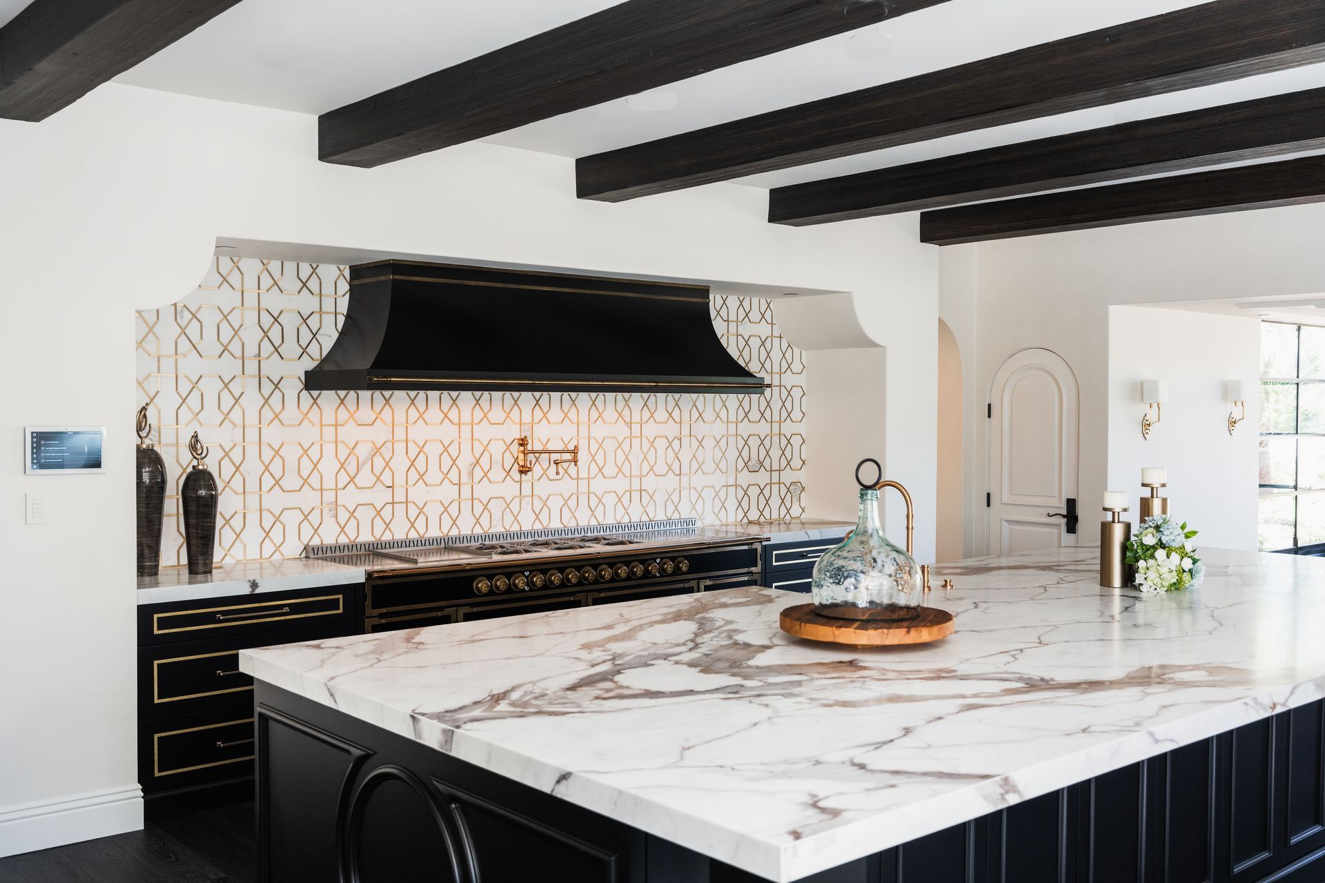 A kitchen with a large island and a stove top oven.