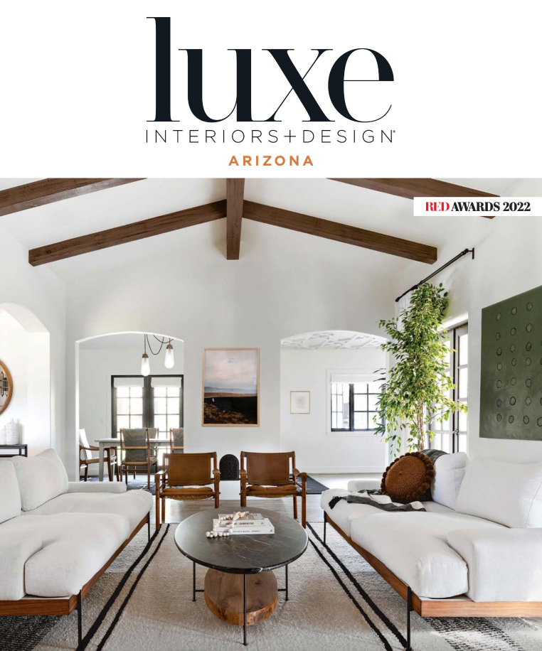 A living room with a couch , chairs , and a table on the cover of luxe interiors + design arizona.