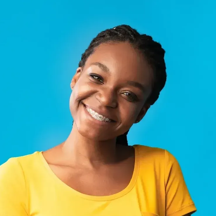 Teenage girl with braces and a yellow shirt on
